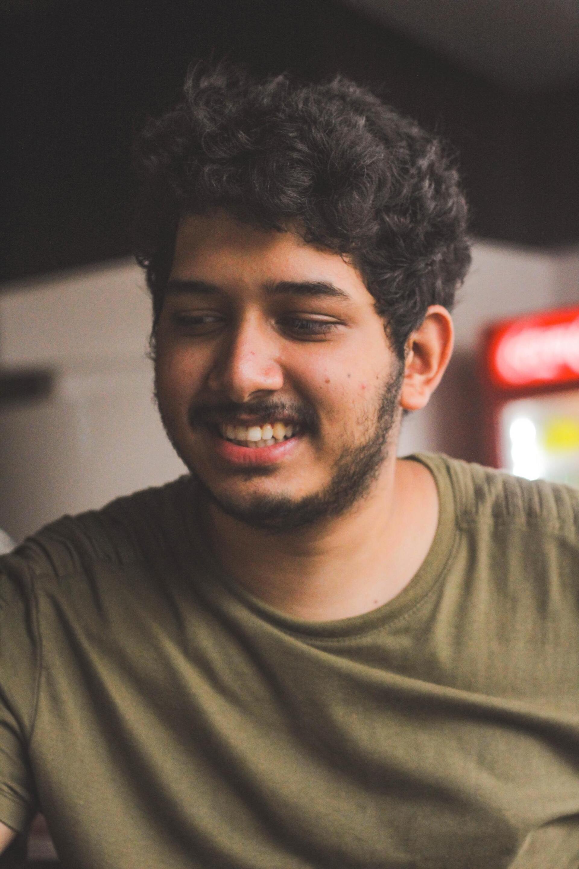 men with round faces: man with a round face and curly brown hair