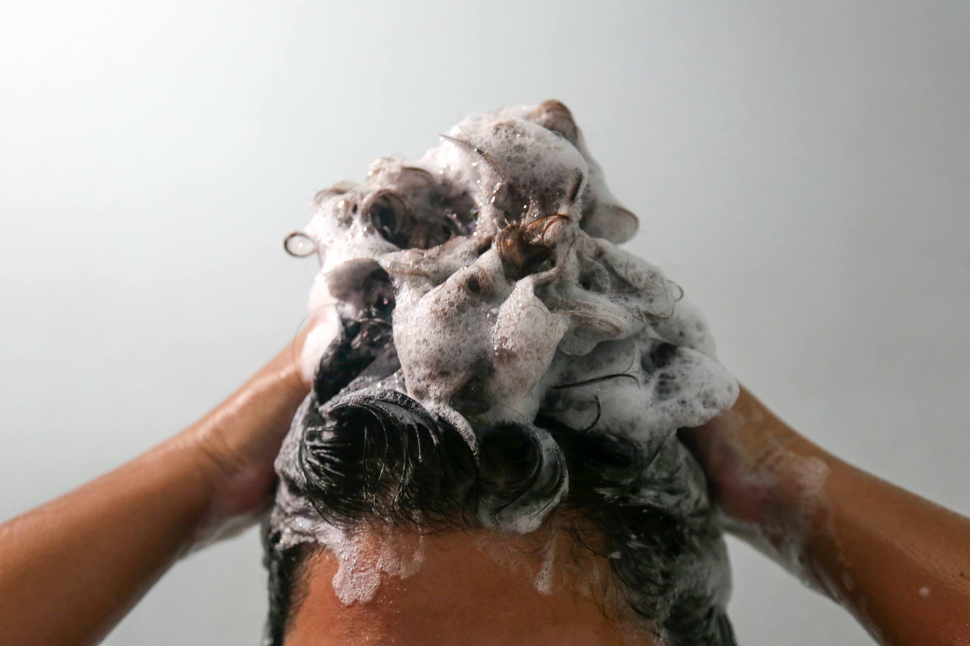 green tea shampoo: close-up shot of a woman washing her hair