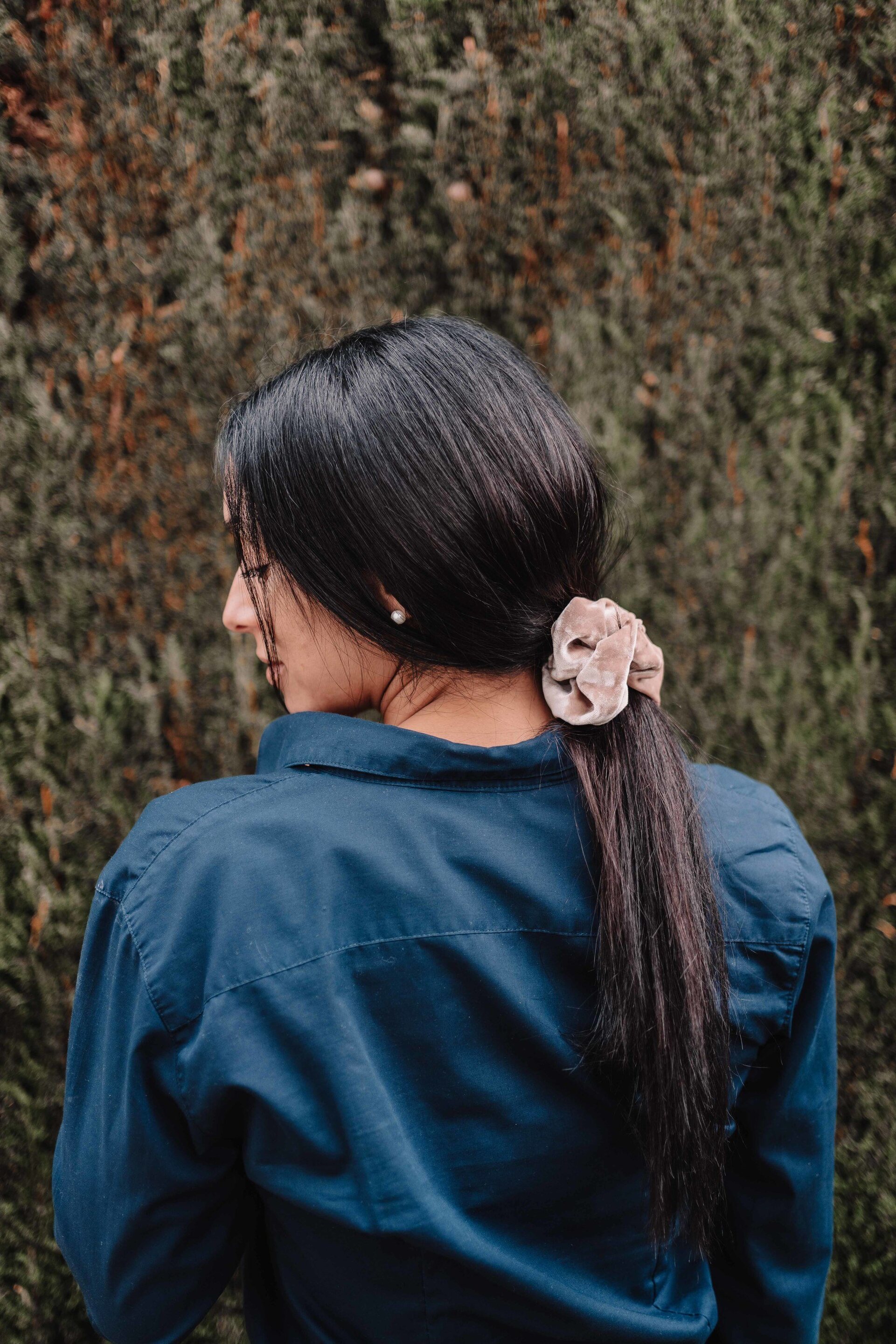 Woman with pink hair scrunchie and poyntail