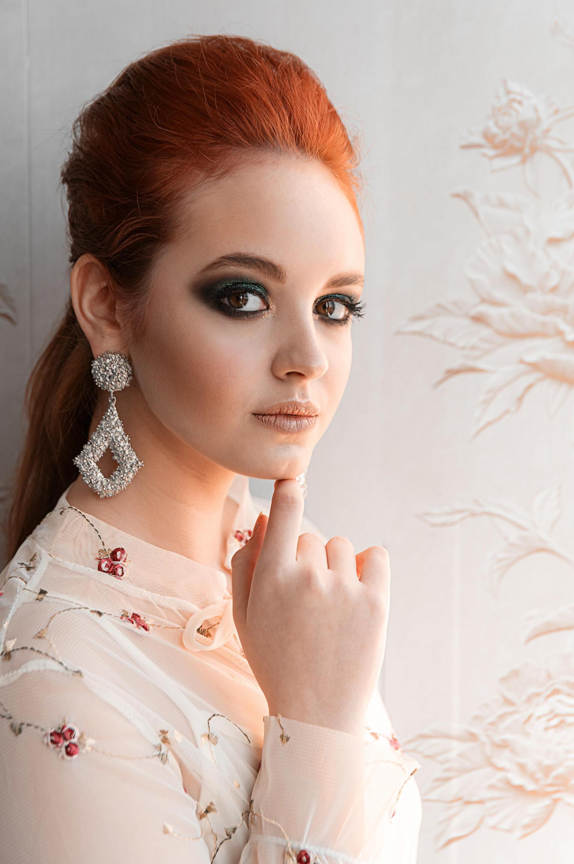 woman with red hair and a sleek ponytail