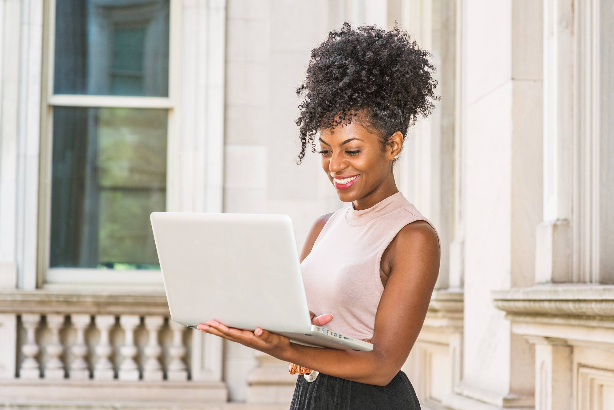 day to night: woman with a high puff natural hairstyle and stretched curls fringe
