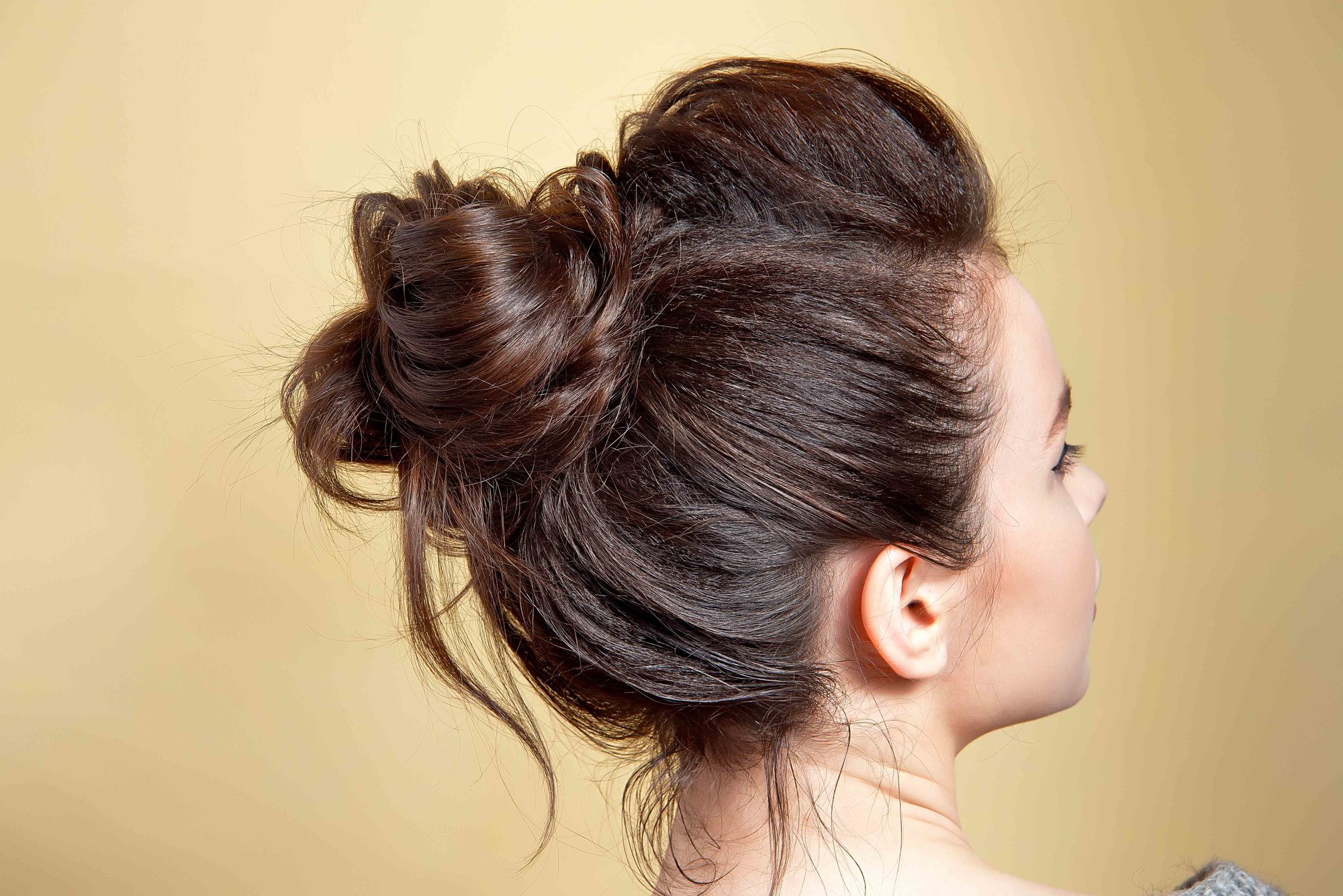 day to night: woman with a loose, messy bun hairstyle