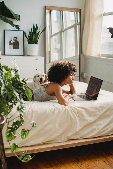 Holiday indoors: woman catching up on her watch list