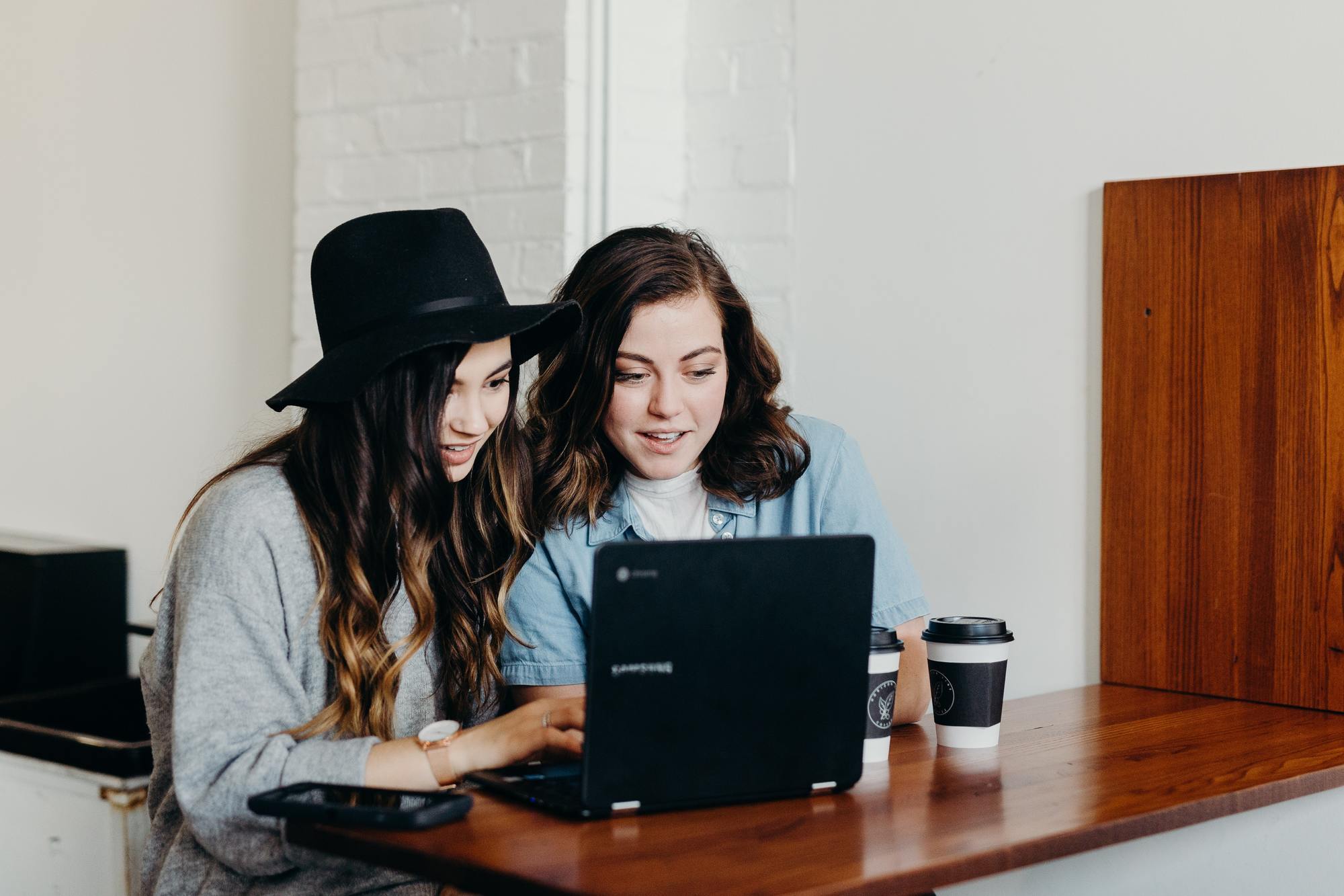 Black Friday tip: image of two woman seated together in front of a laptop