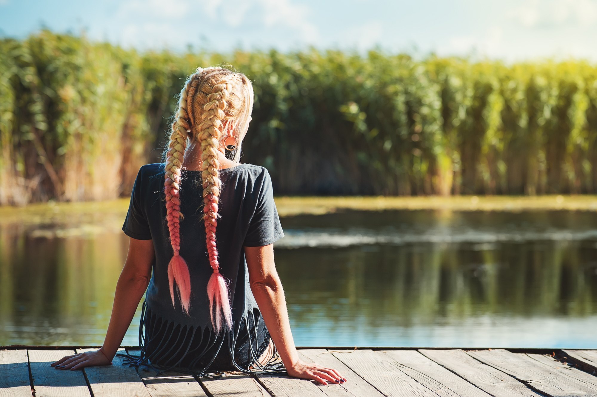 beach-lovers hairstyle: woman with long blonde and pink hair wearing two braids