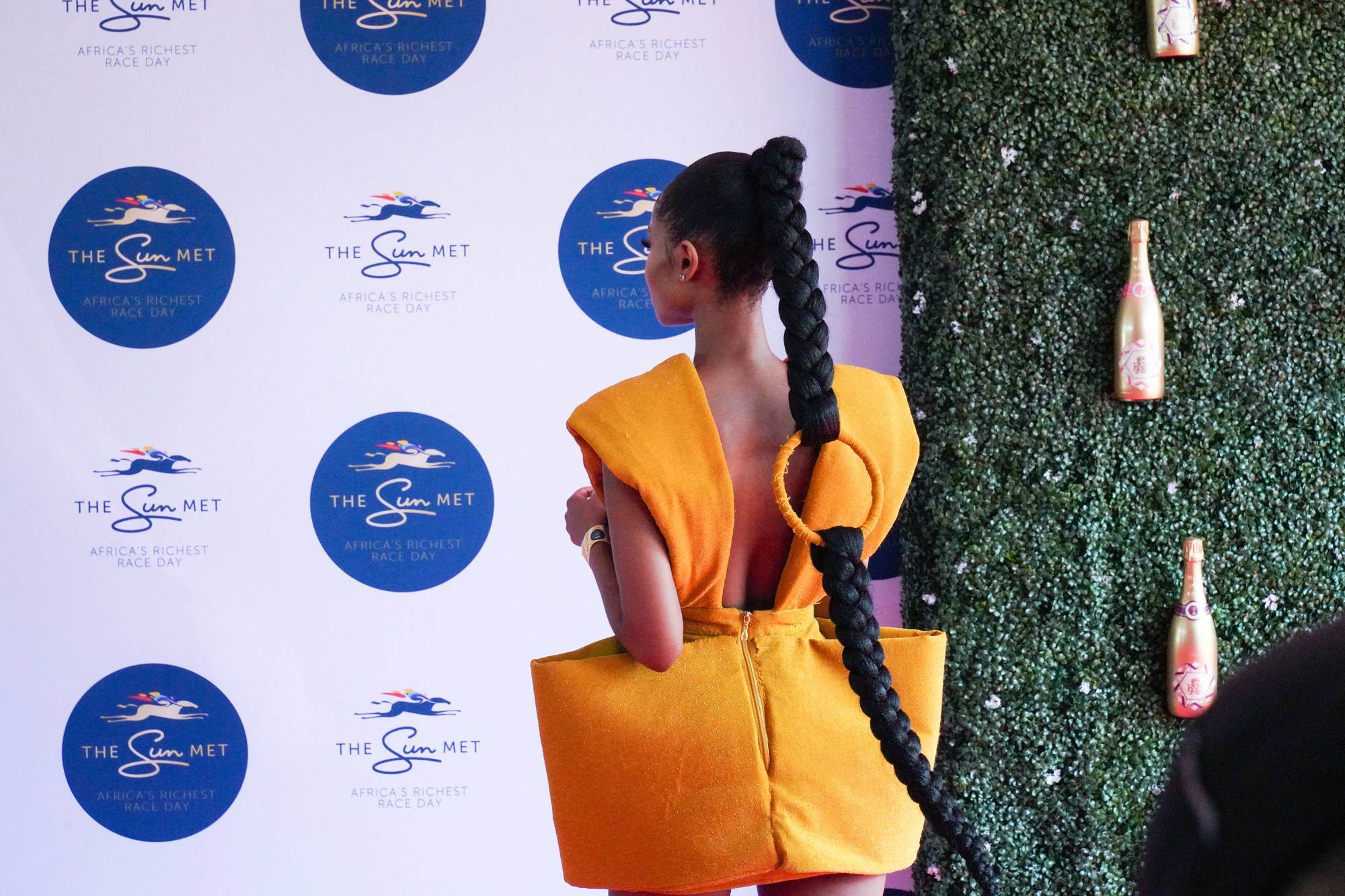 Woman with ponytail and extra long braid connect with a big orange ring
