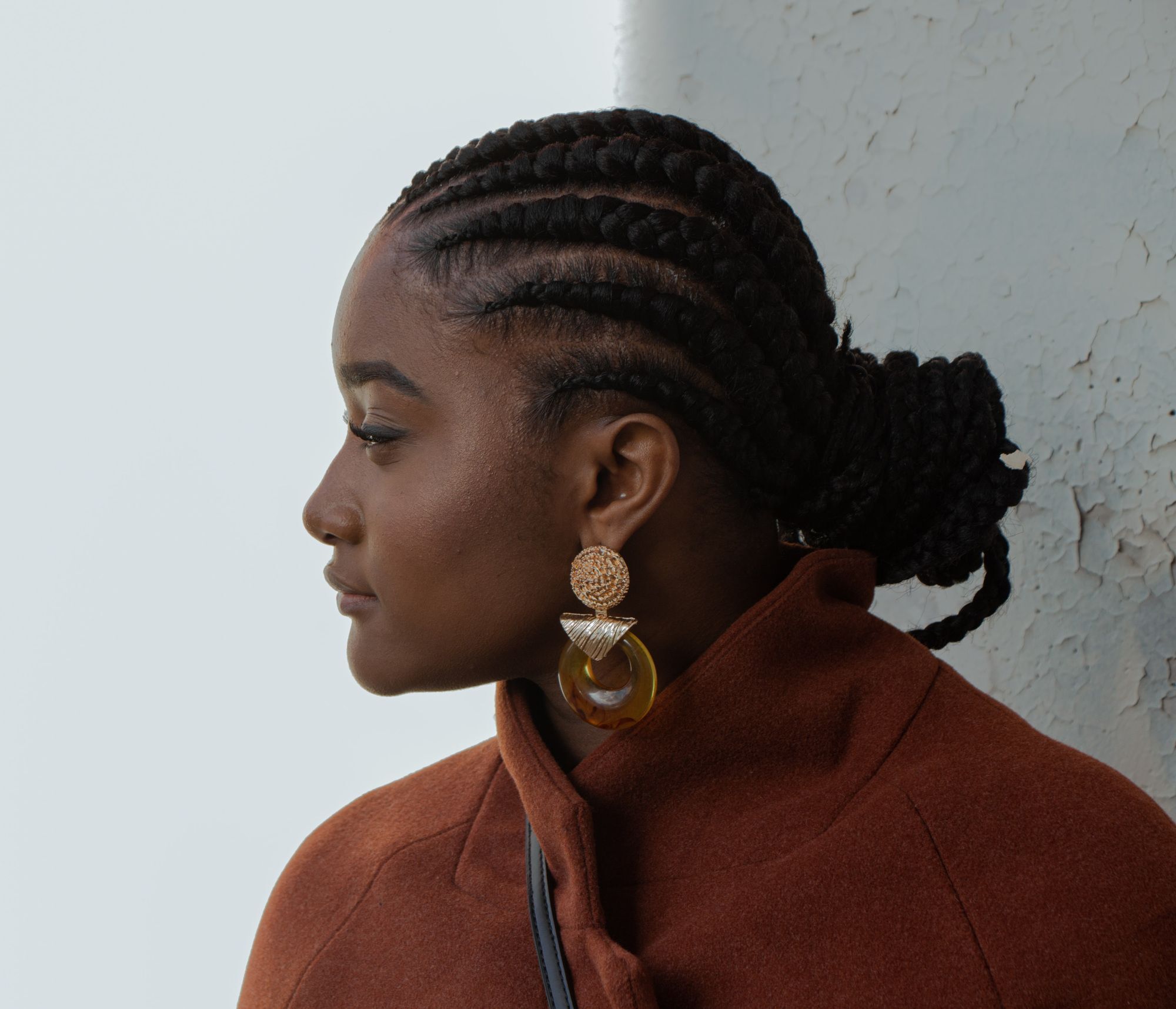 woman with straight back cornrows and low bun