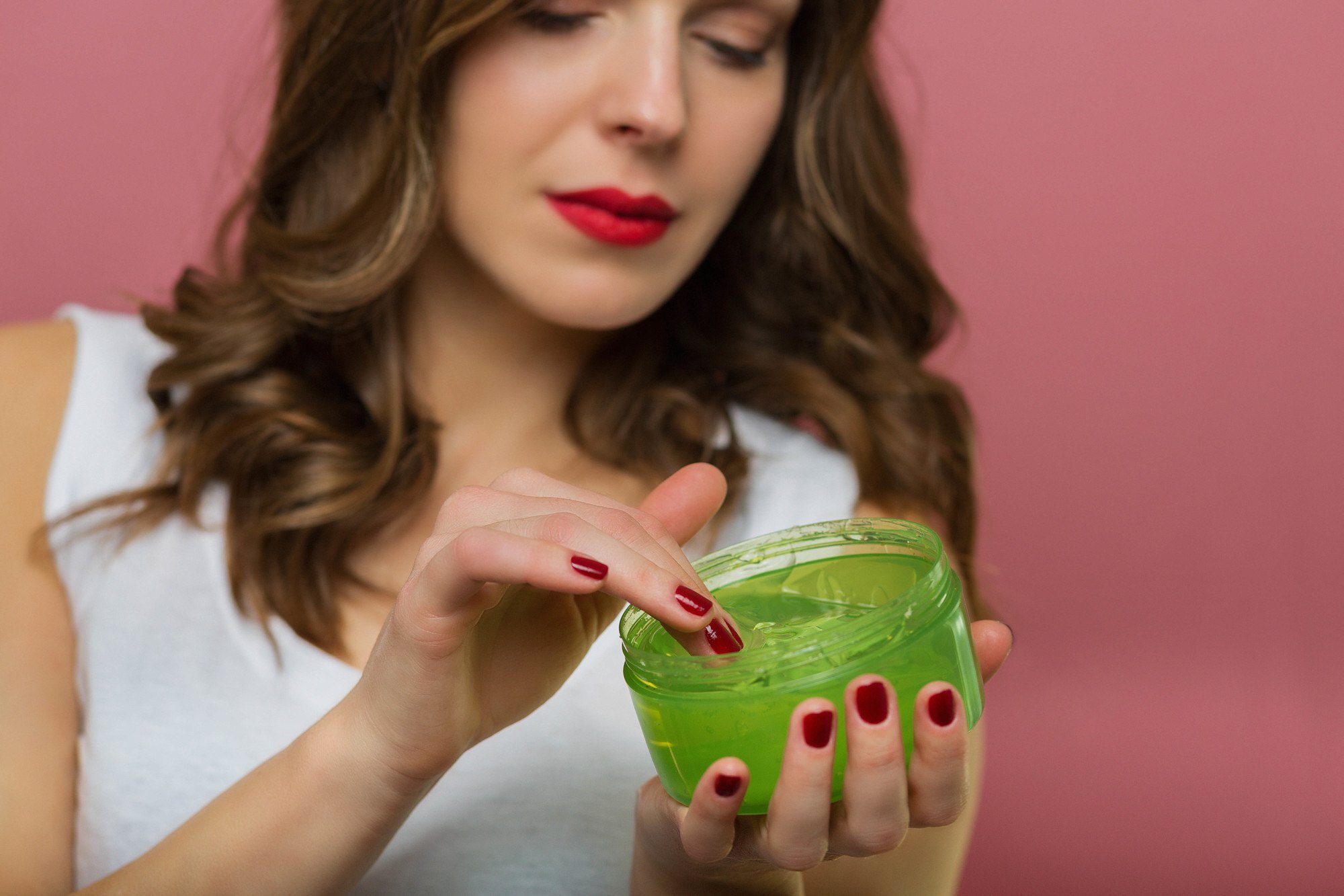 Woman holding a tub of hair gel