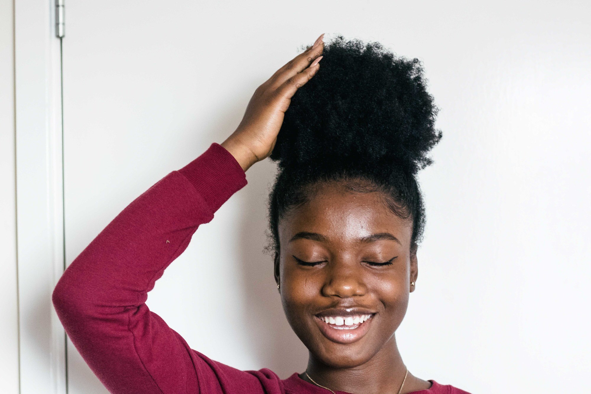 woman with natual hair high puff hairstyle