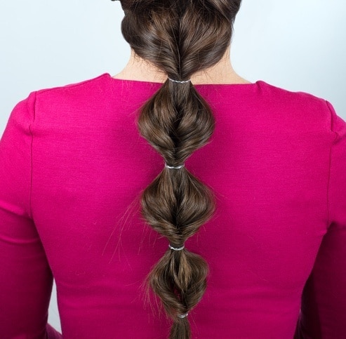 woman with a low ponytail yoga hairstyles