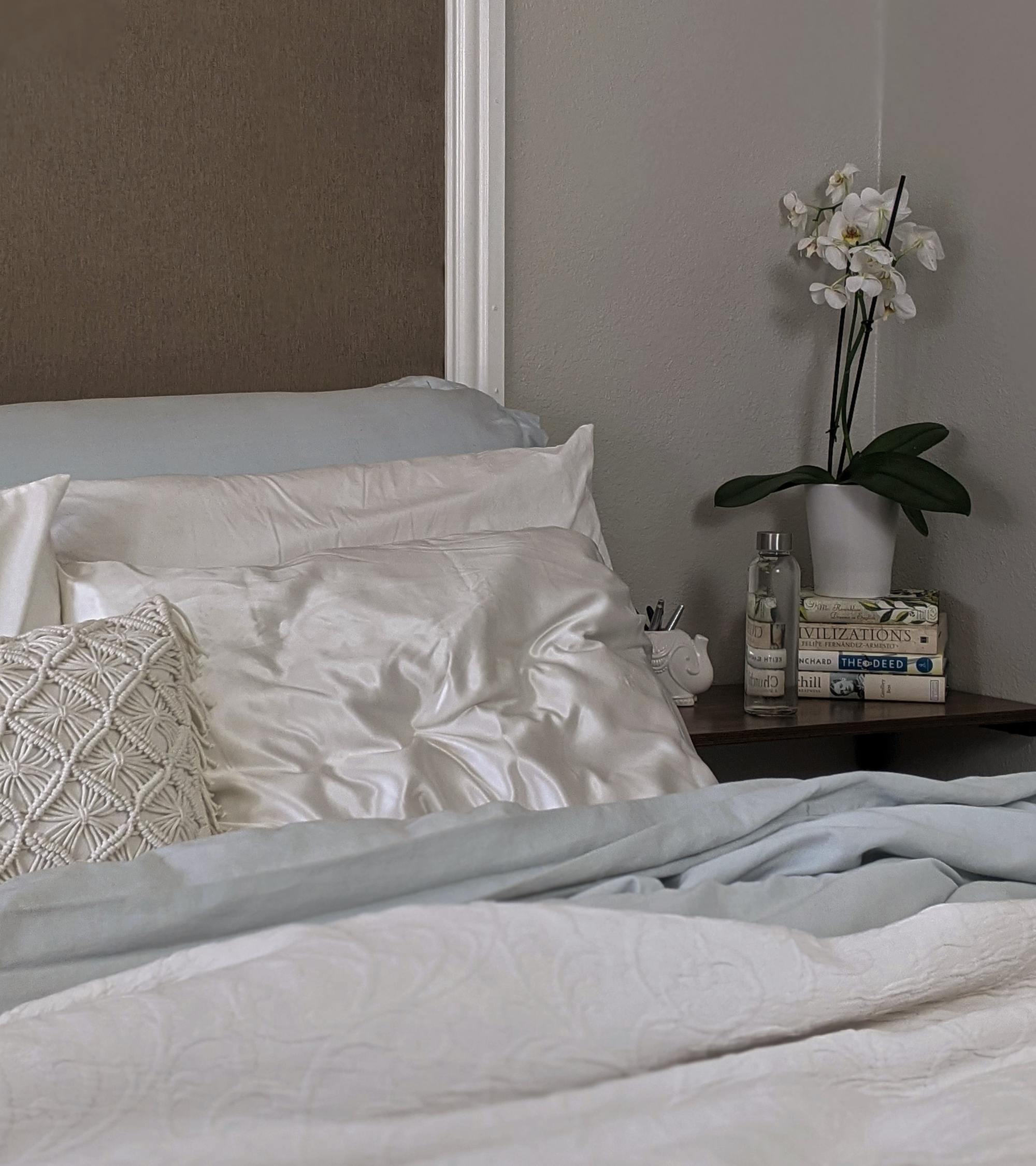 flyaway tips: image of a bed with a white satin/silk pillow
