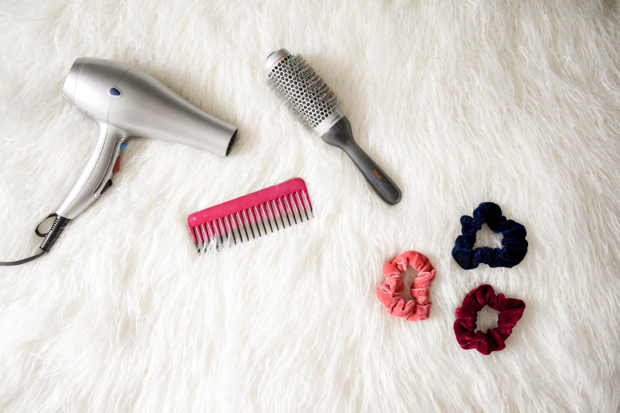 flyaway hair tips: image of a hairdryer, pink and blowdrying barrel brush, and three scrunchies