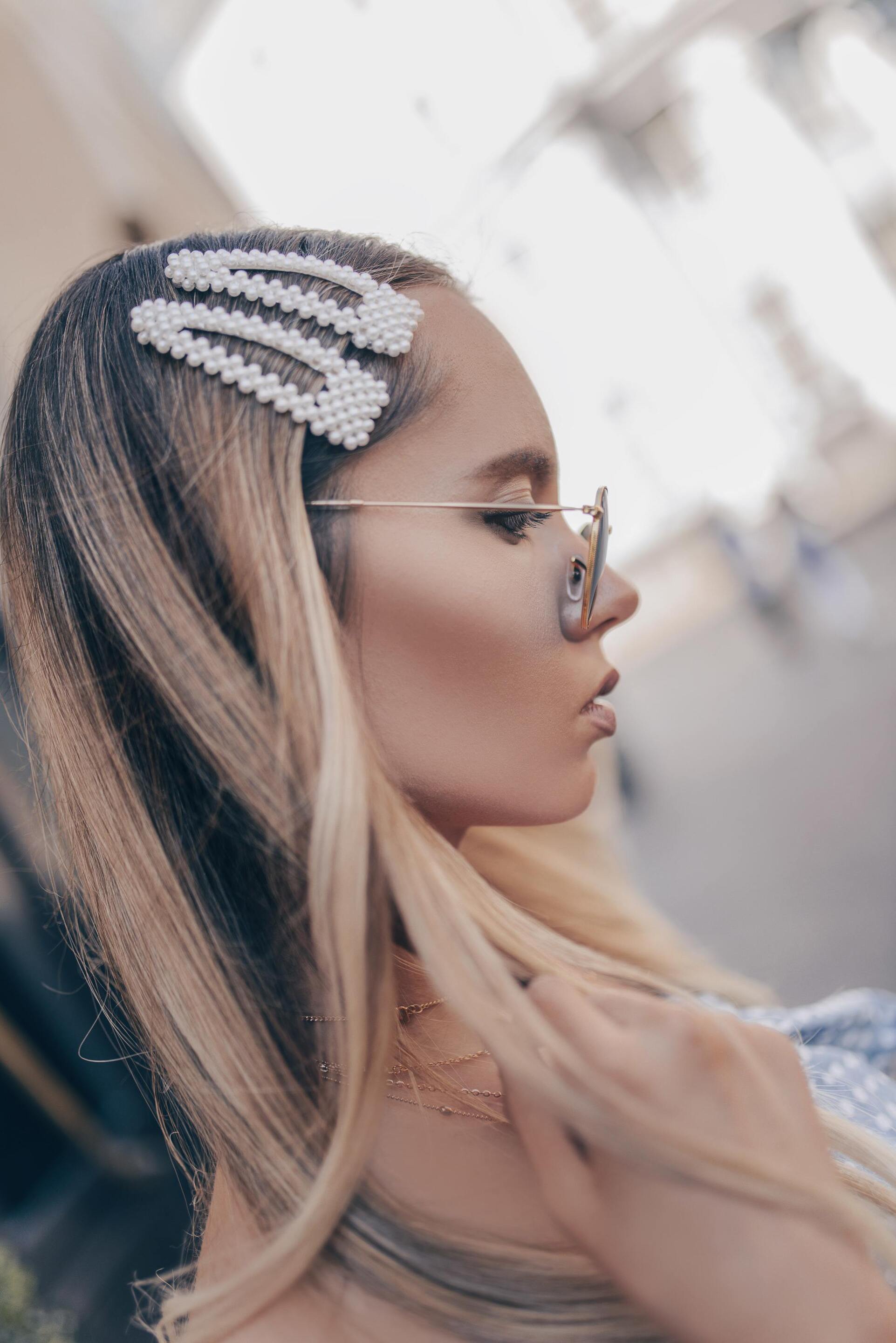 growing out an undercut: woman with long brown hair big accessories trend