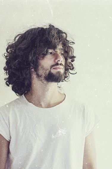 man with soft curls curly hair medium short hair