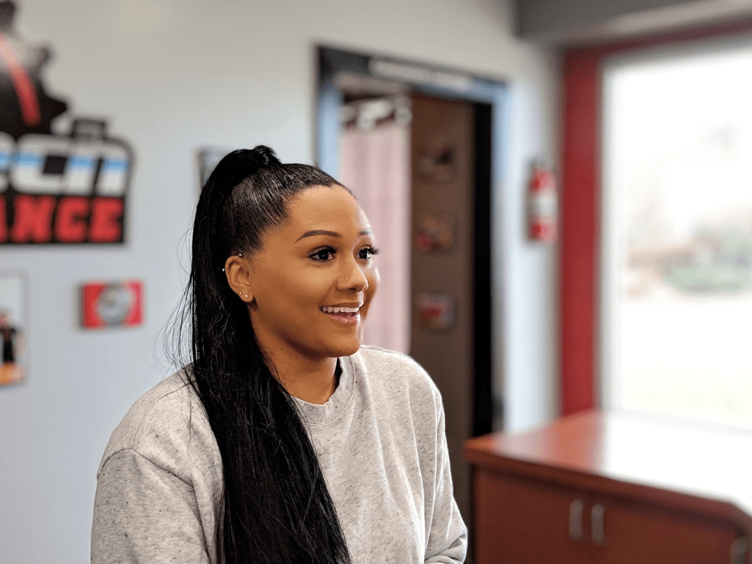 hair hacks for thick hair: woman with a sleek, very high ponytail and long black hair