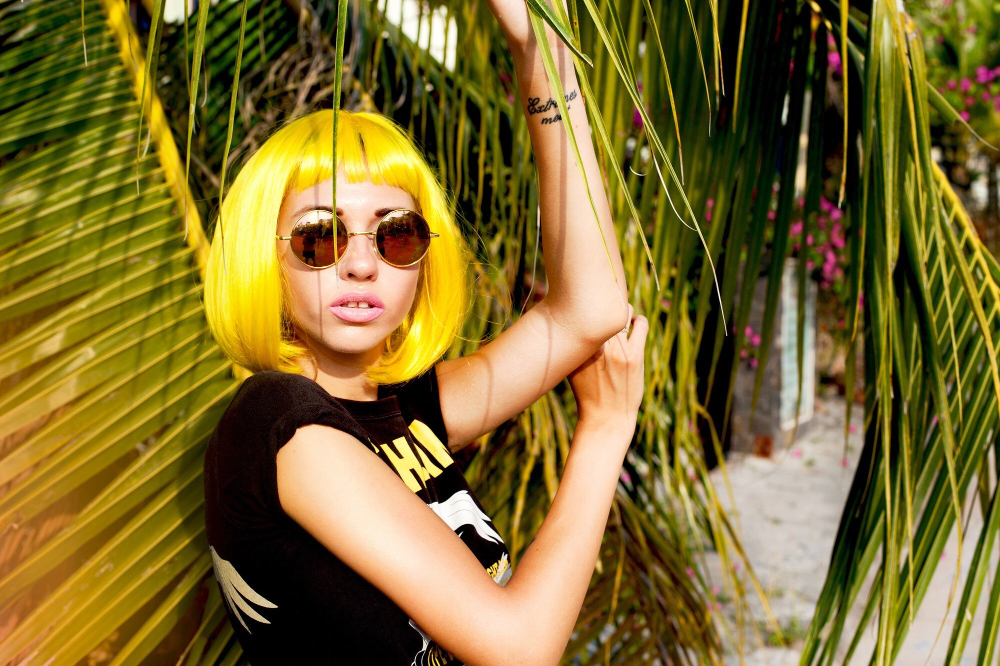 birthstone-inspired hair colour: woman with bob haircut and bright yellow hair