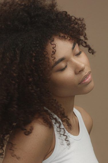 woman with tight curls curly hair afro
