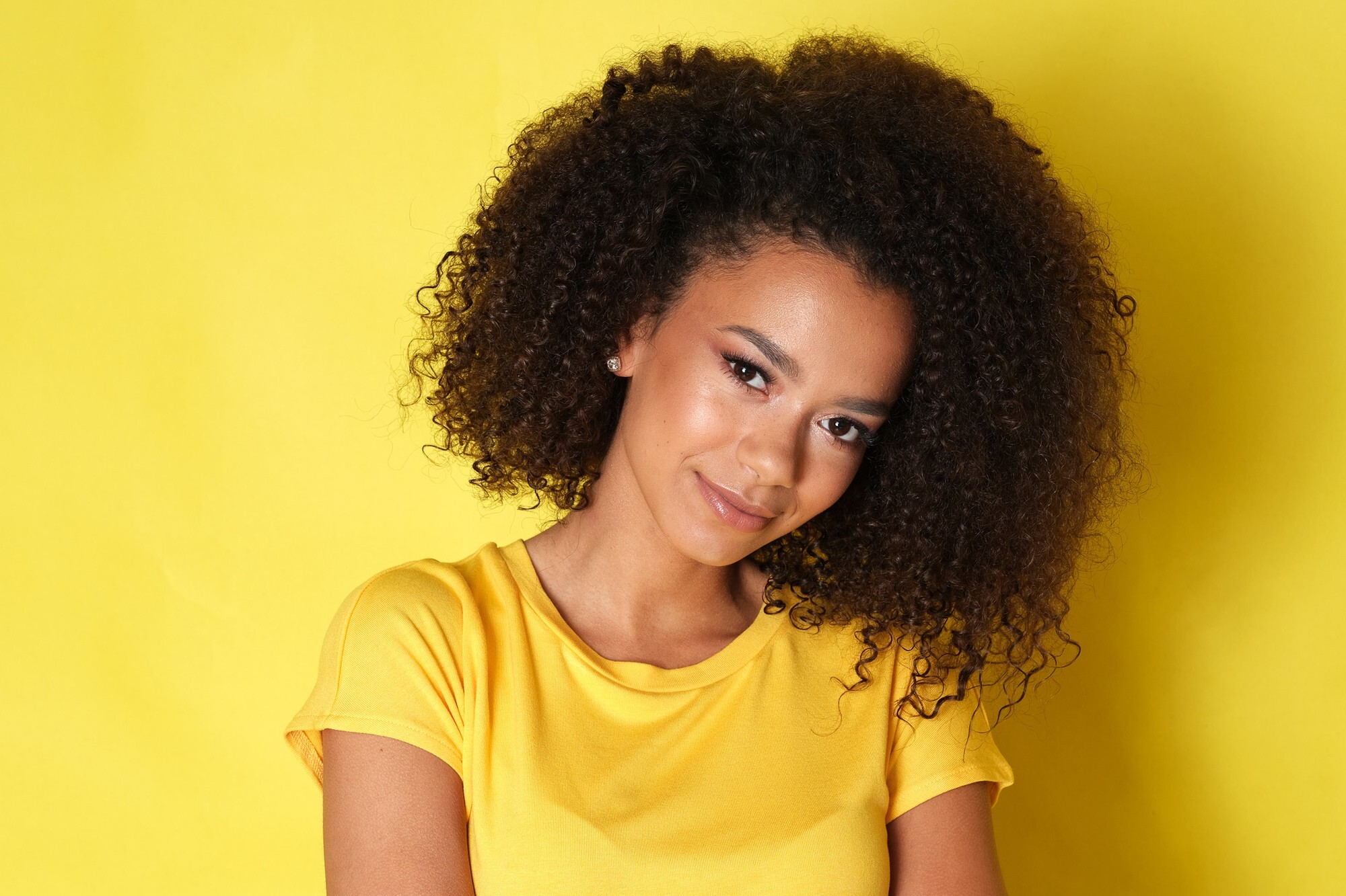 woman with big voluminous curly hair afro