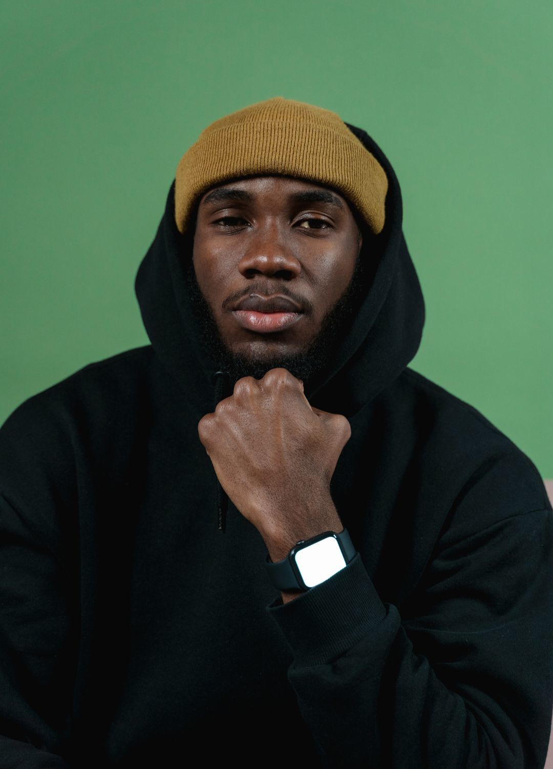 Kpop inspired hairstyle: man wearing a black a hoodie and mustard-coloured beanie