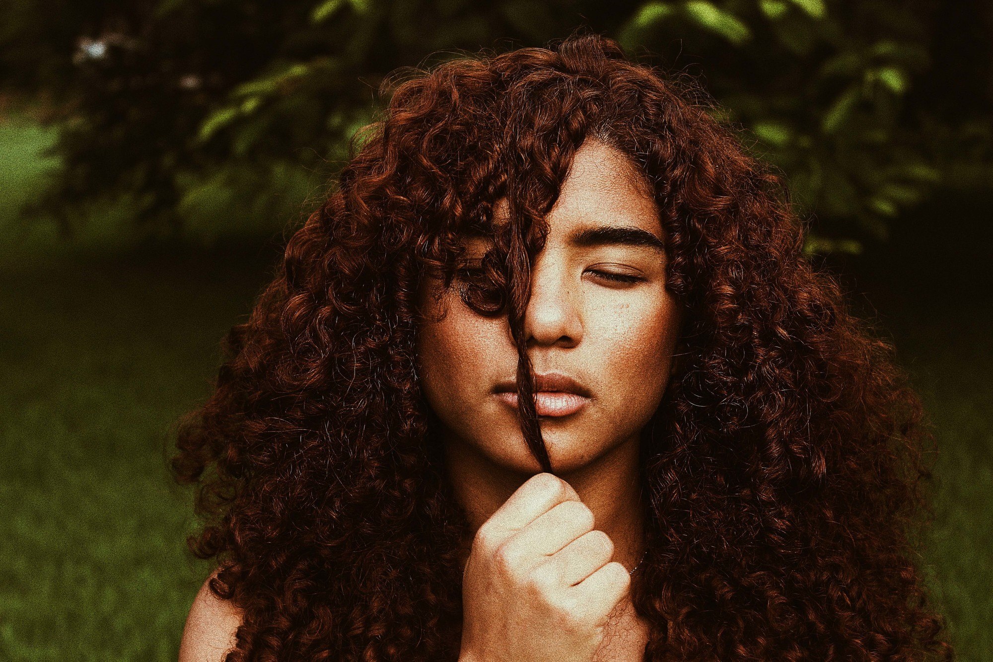 types of hair colour: woman with curly brown hair
