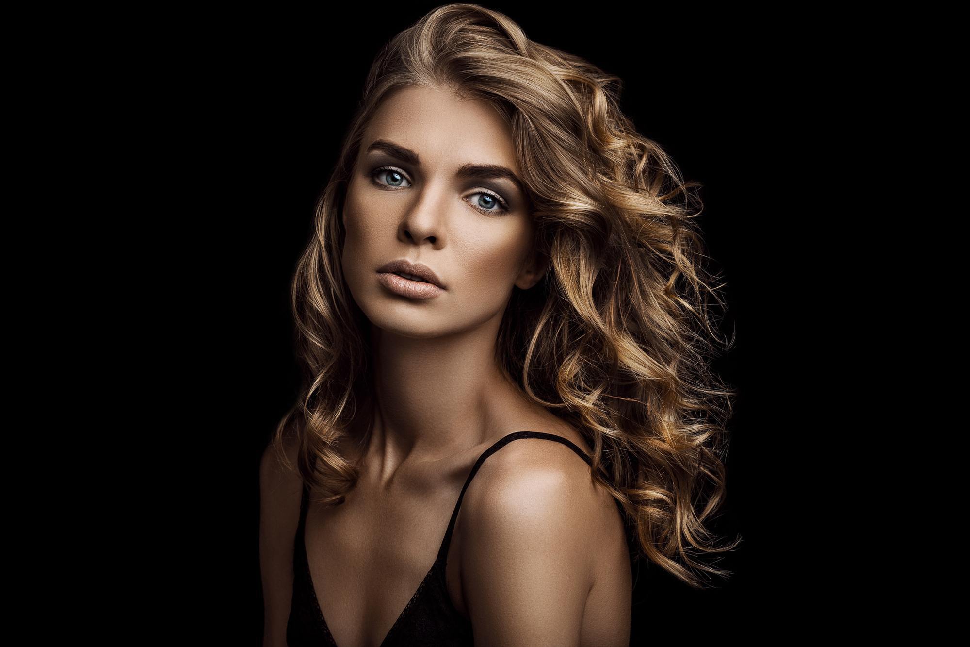woman dark blonde hair defined waves body wave perm