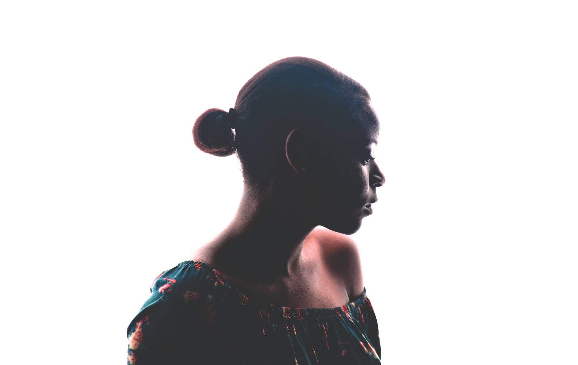 silhouette of a woman with a low ponytail