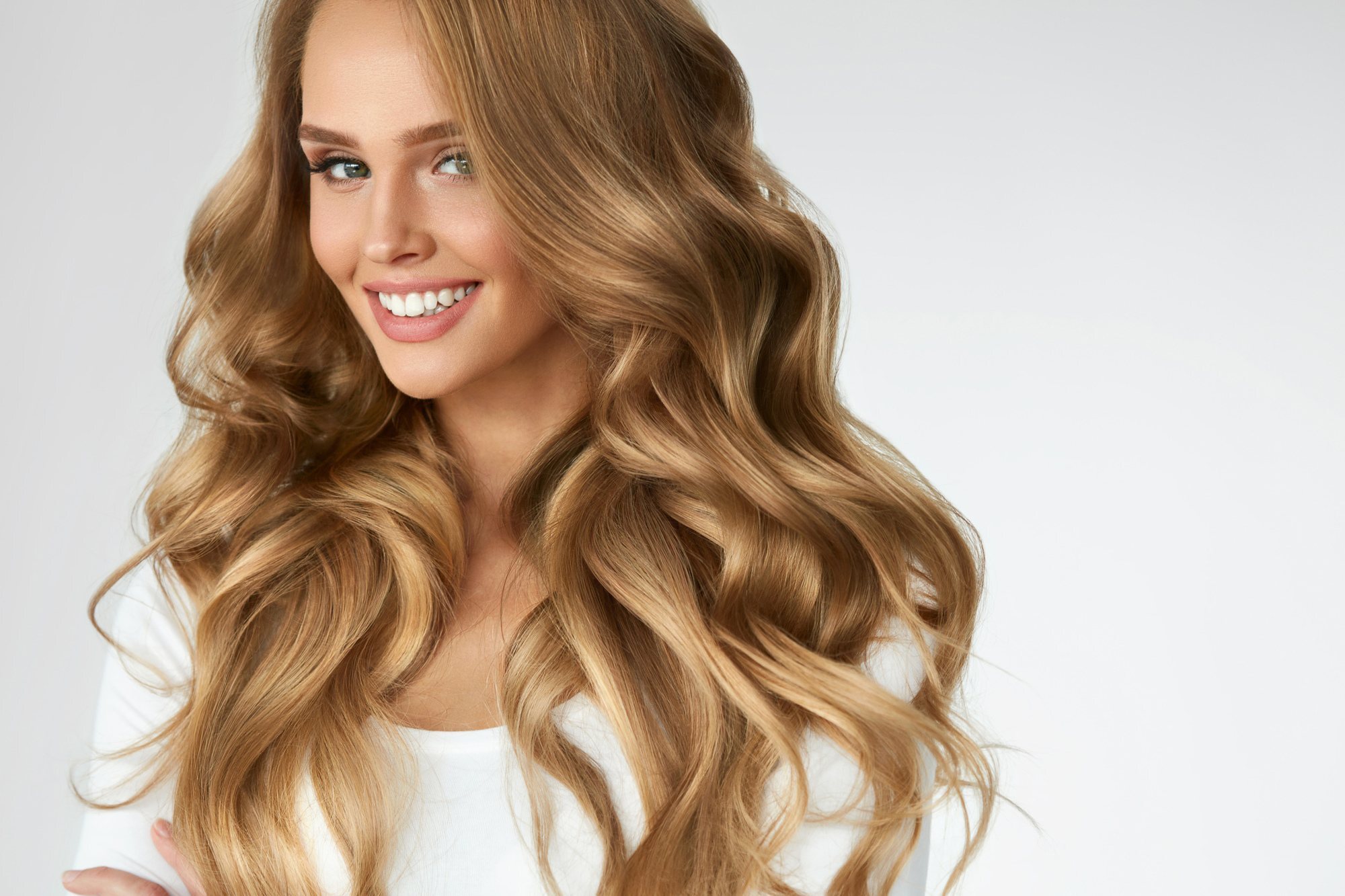 woman with long hair dirty blonde body wave perm wavy hair