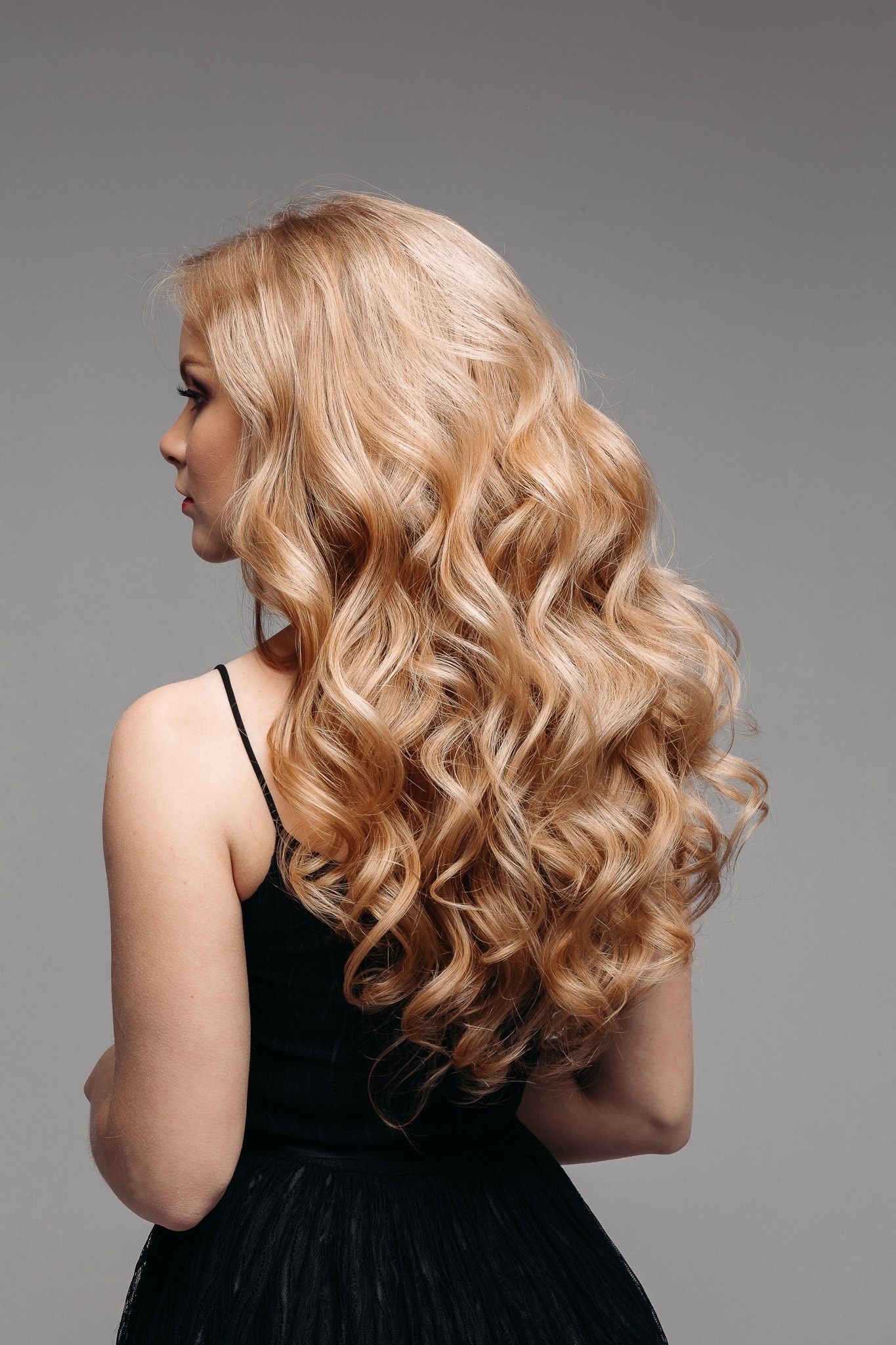 woman with long blonde wavy hair thick hair defined body wave perm