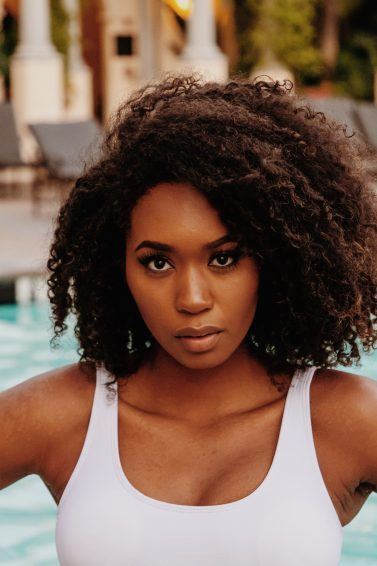 Woman with curly hair swimming