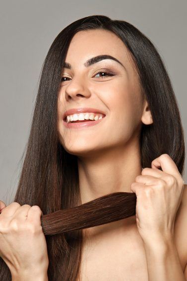 woman holding her hair, Revitalise hair