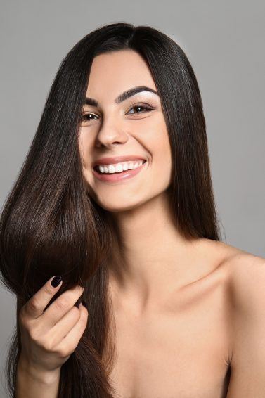 keratin smoothing treatments: woman with long silky brown hair
