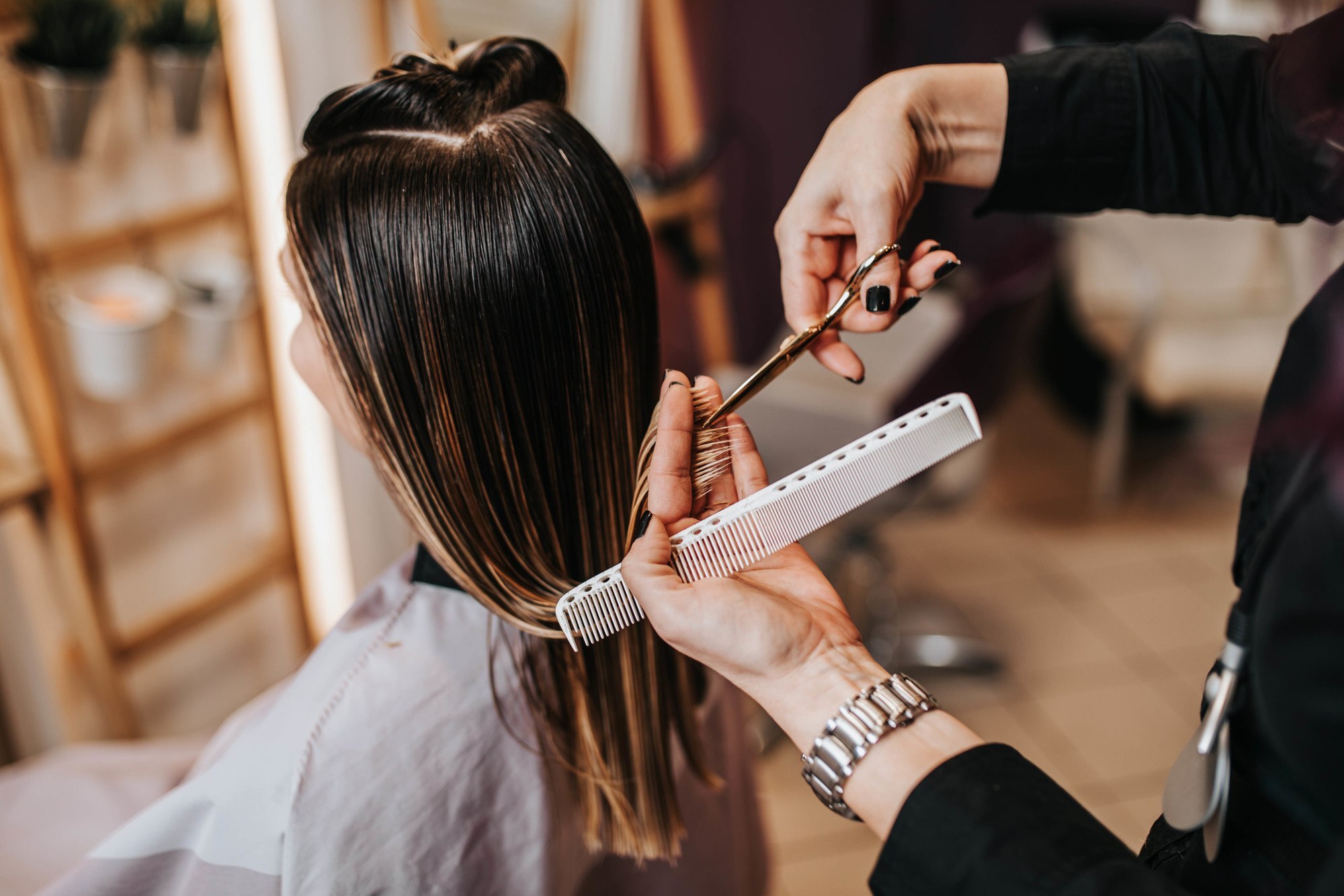 Woman getting her hair trimmed for healthy hair