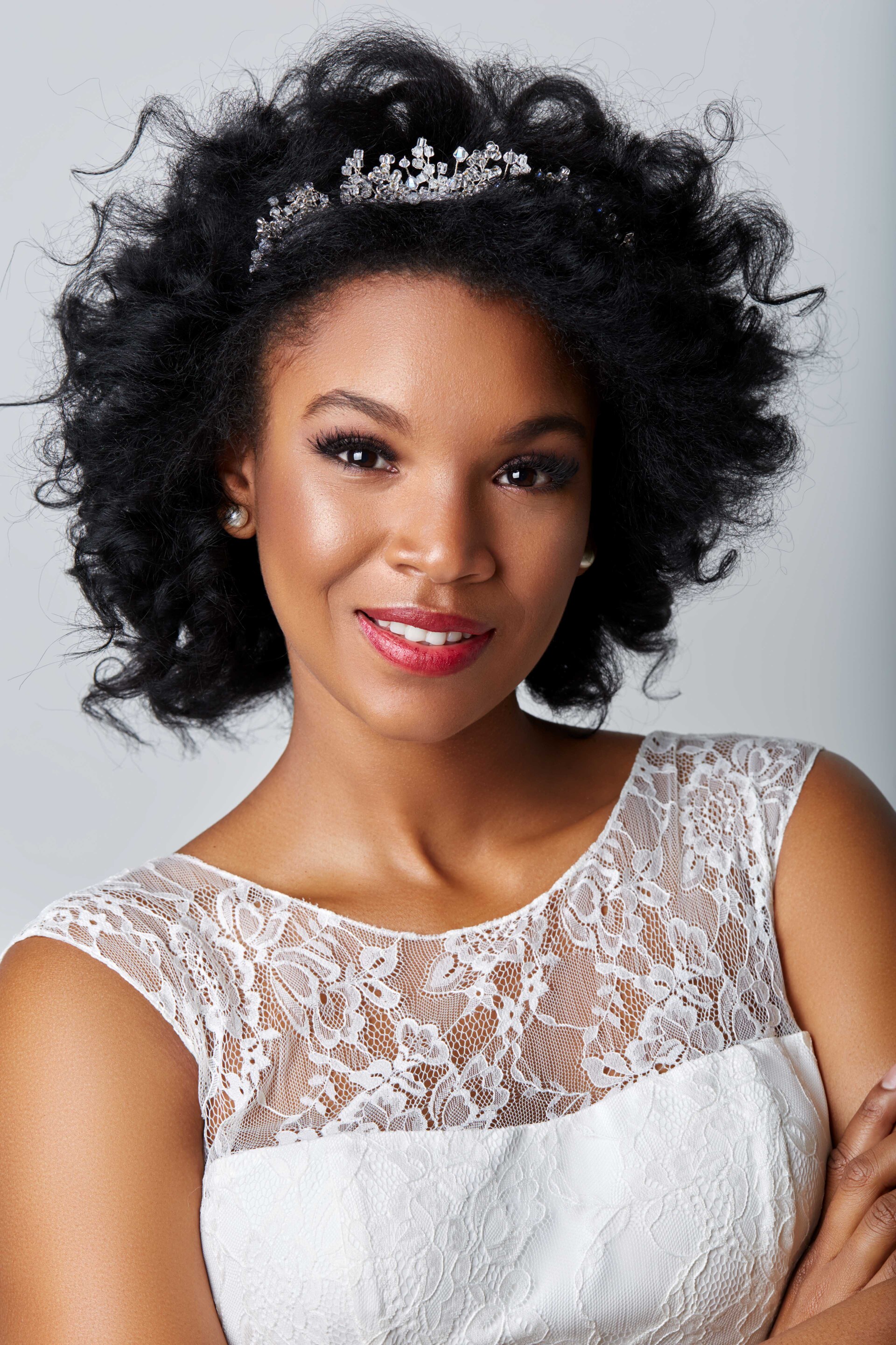 woman with silver tiara and bouncy black curls