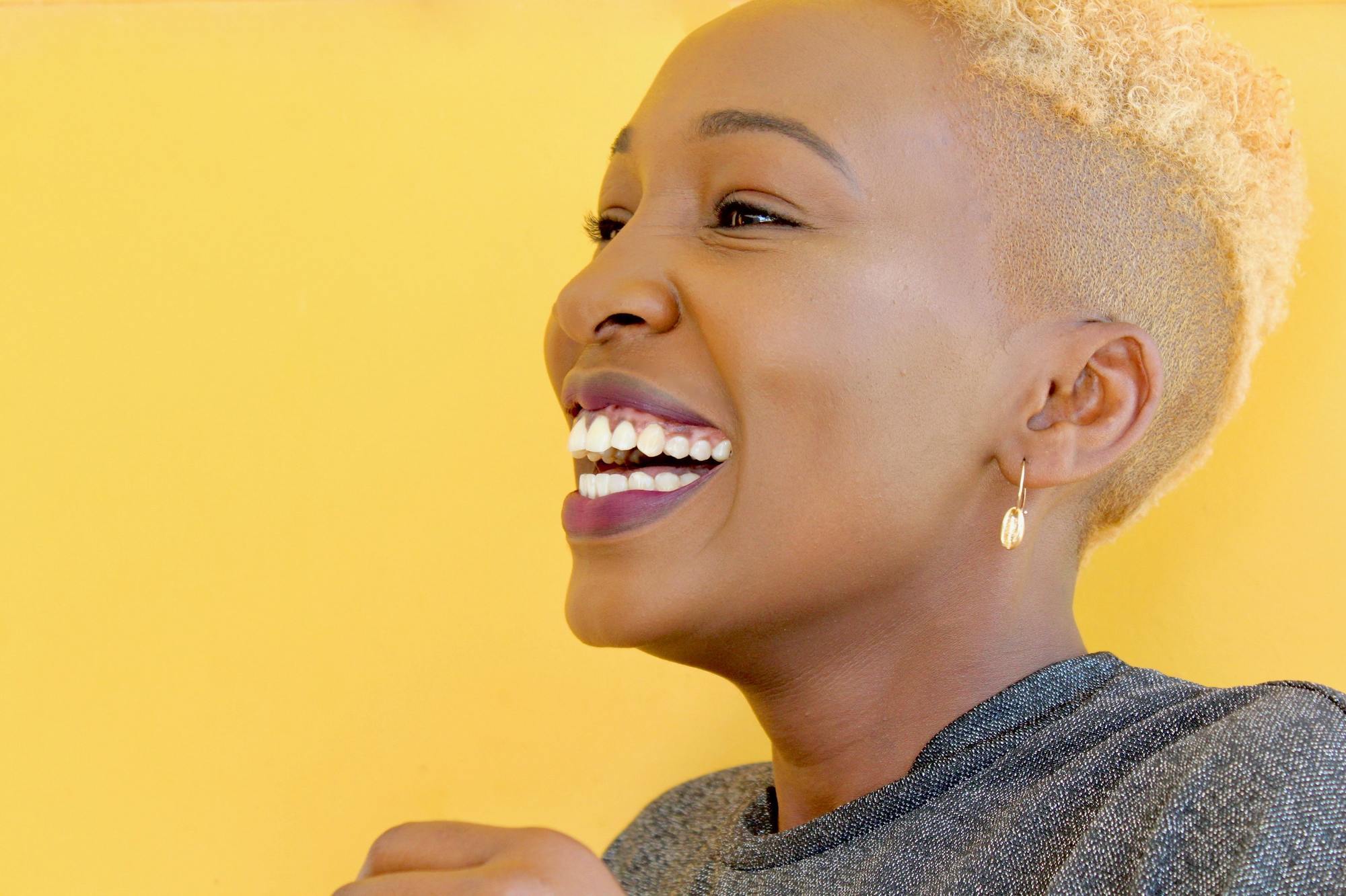 Summer hair colour: woman with very short, pale blonde natural hair in a fade haircut