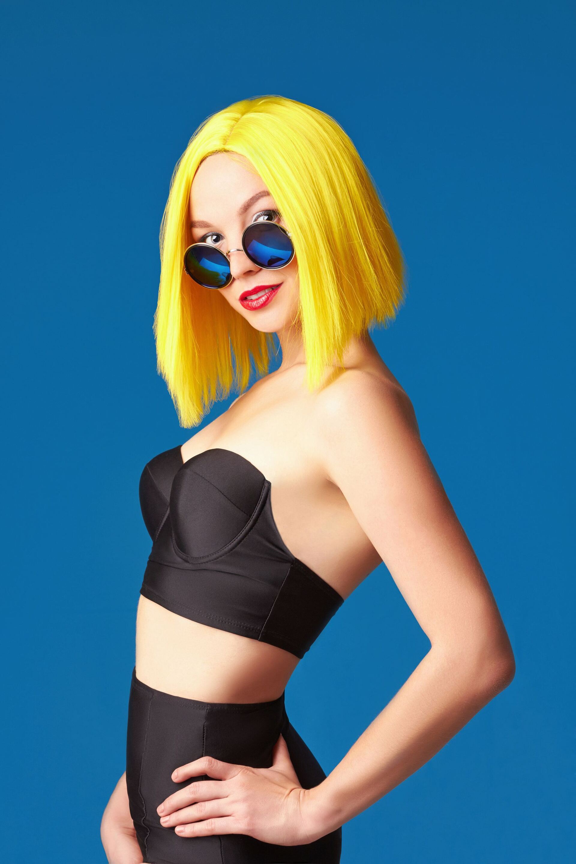 summer hair colour: woman with bright yellow hair cut in a bob hairstyle