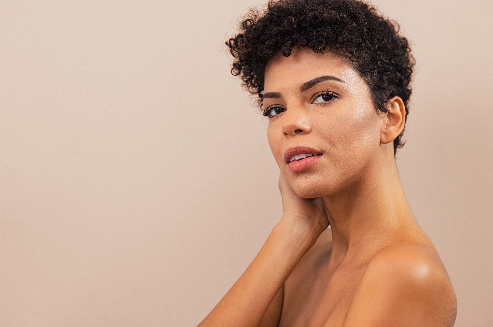 woman with short pixie cut and curly hair