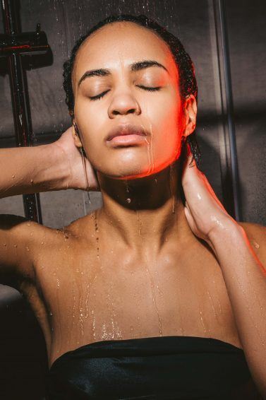 woman with wet hair using leave-in conditioner