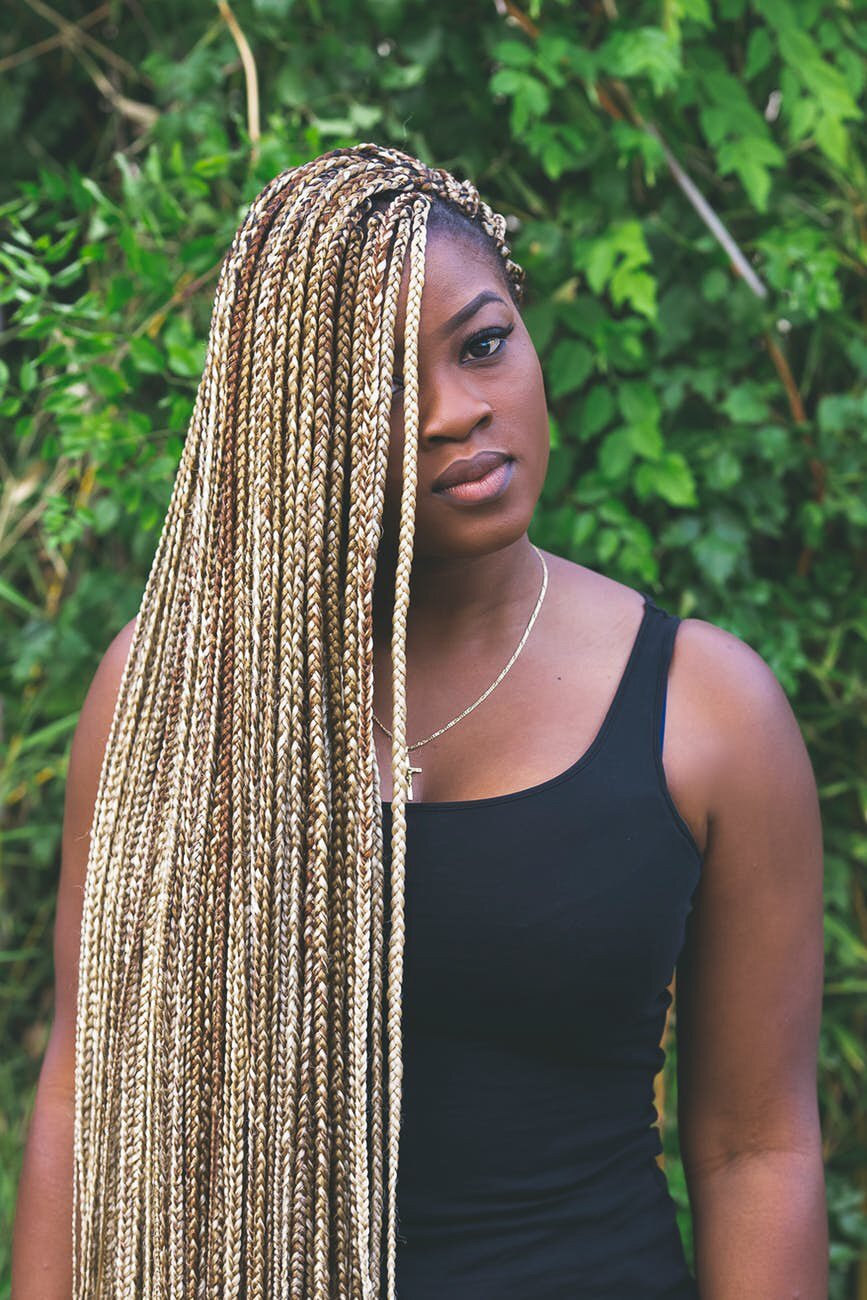 woman with long blonde and brown box braids