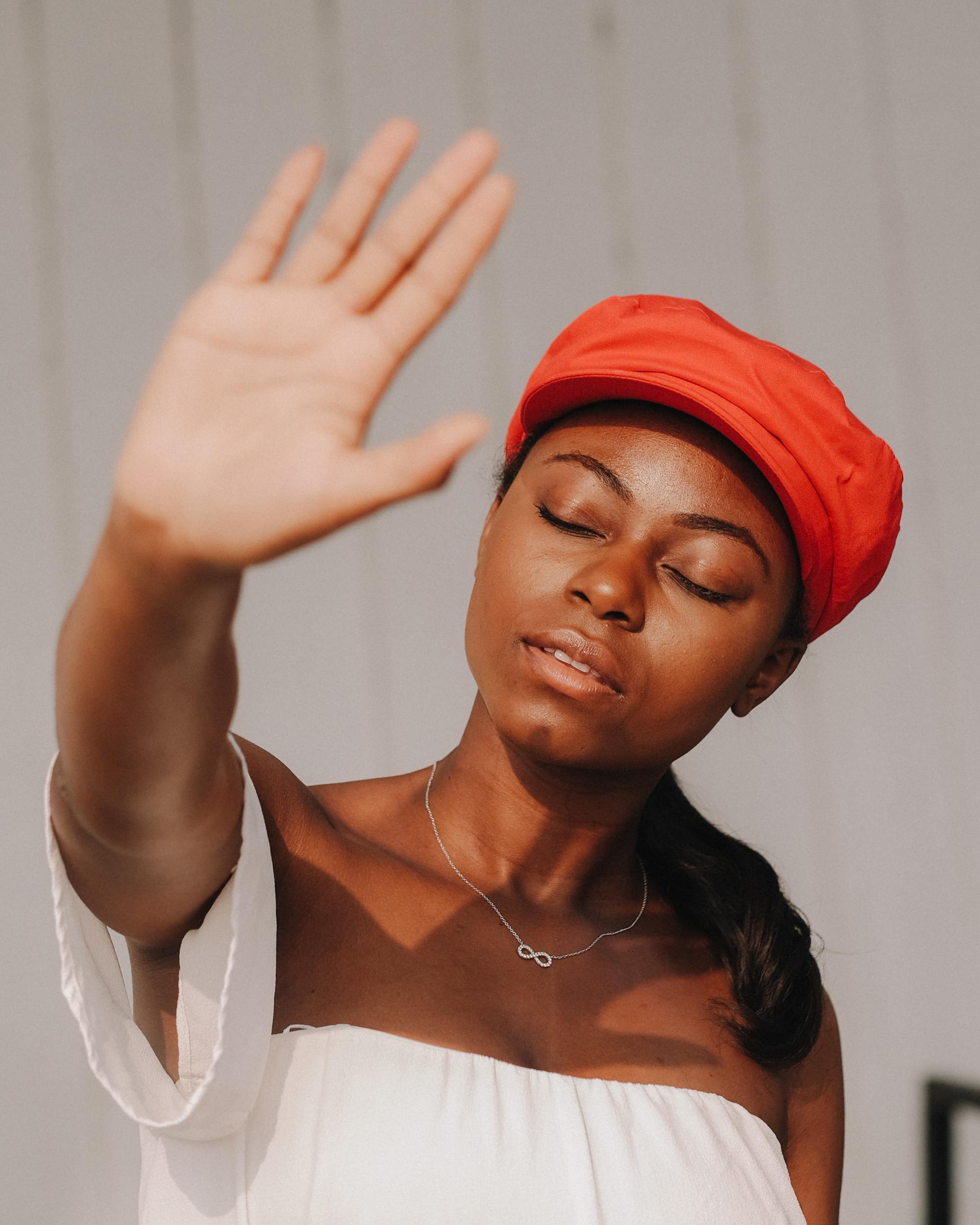 Woman wearing a bright red pageboy-style cap