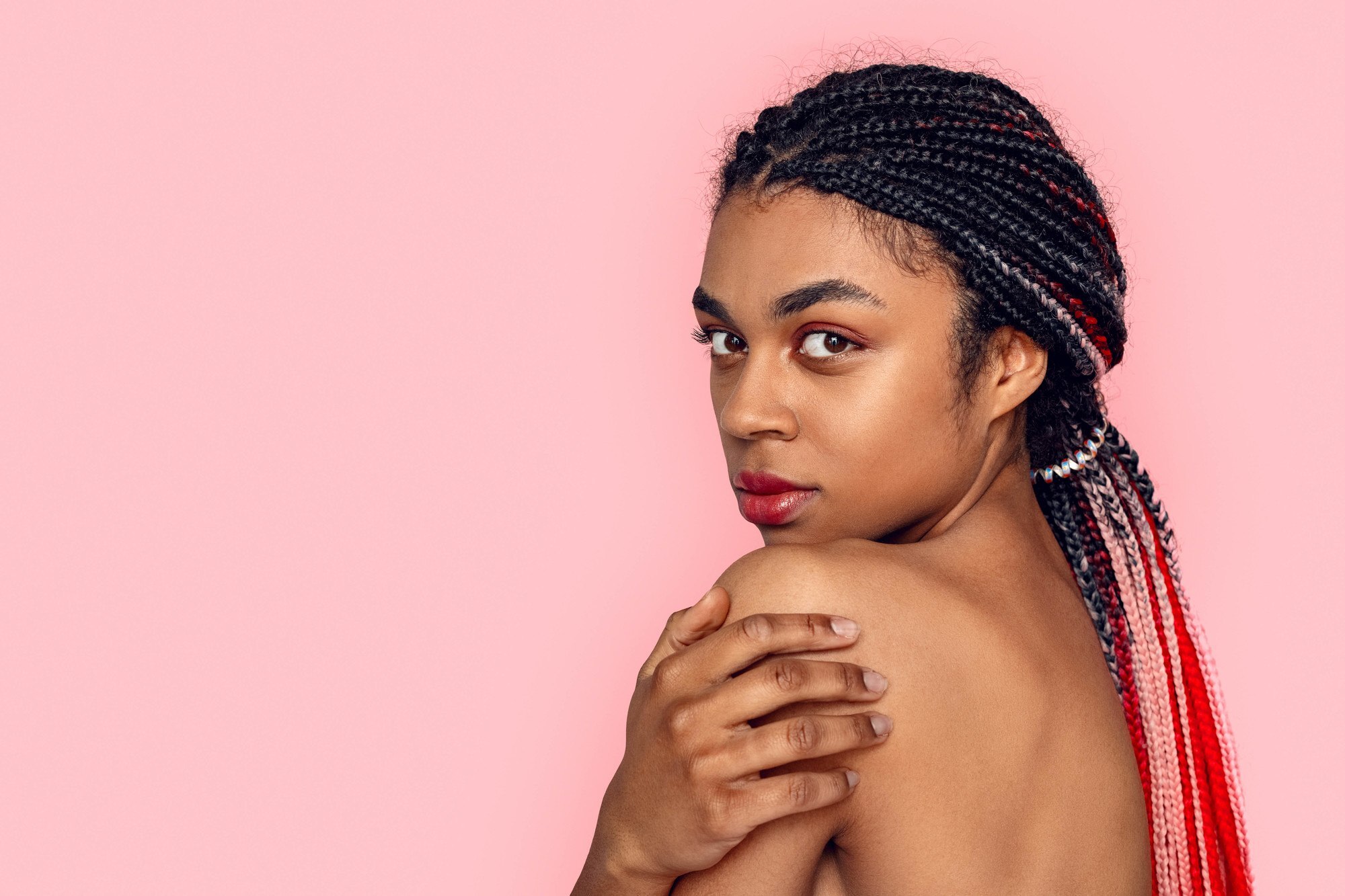 woman with braids tied in a ponytail hairstyle