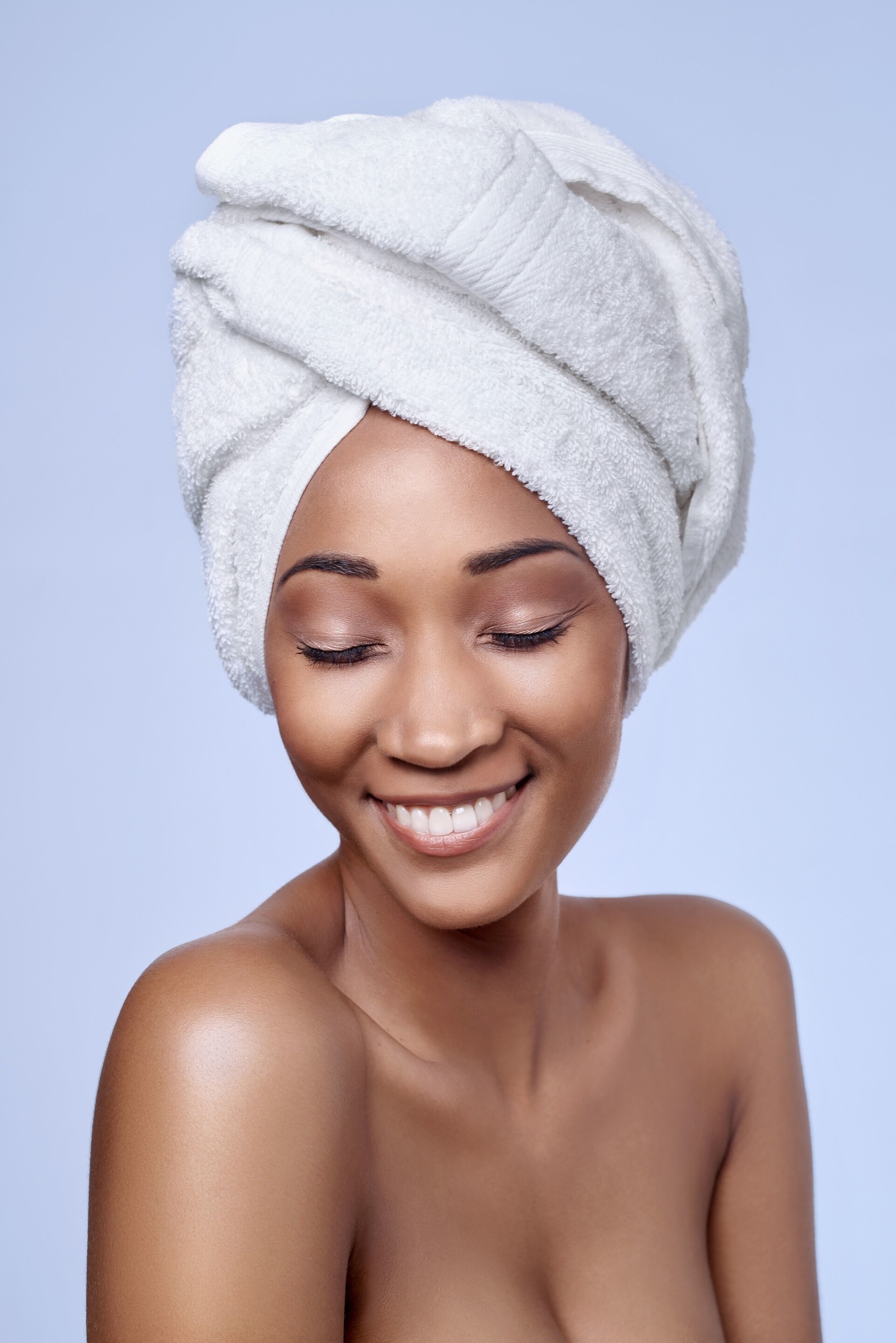 decrease damage: woman wearing a towel after washing hair
