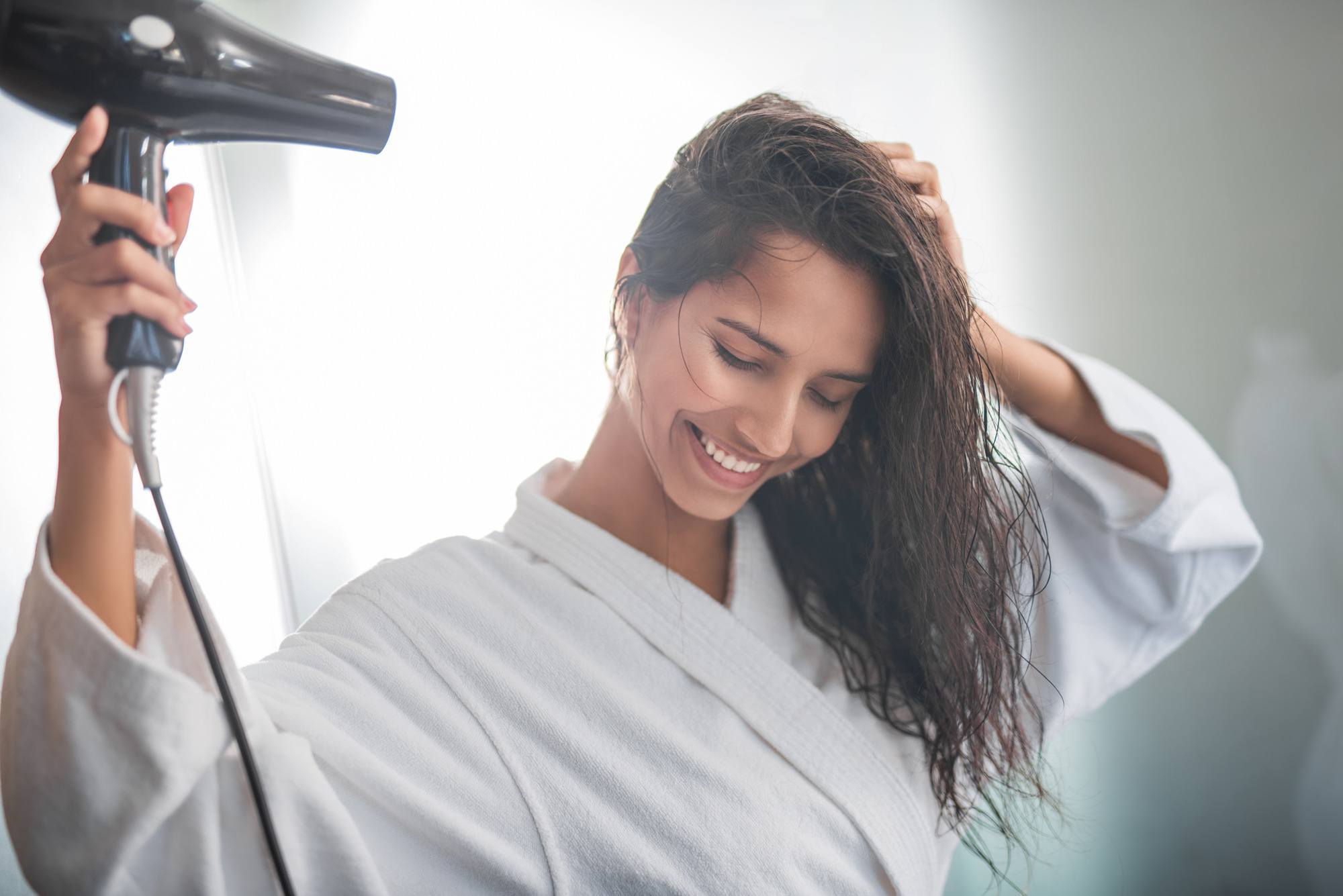 decrease damage: woman using a hair dryer