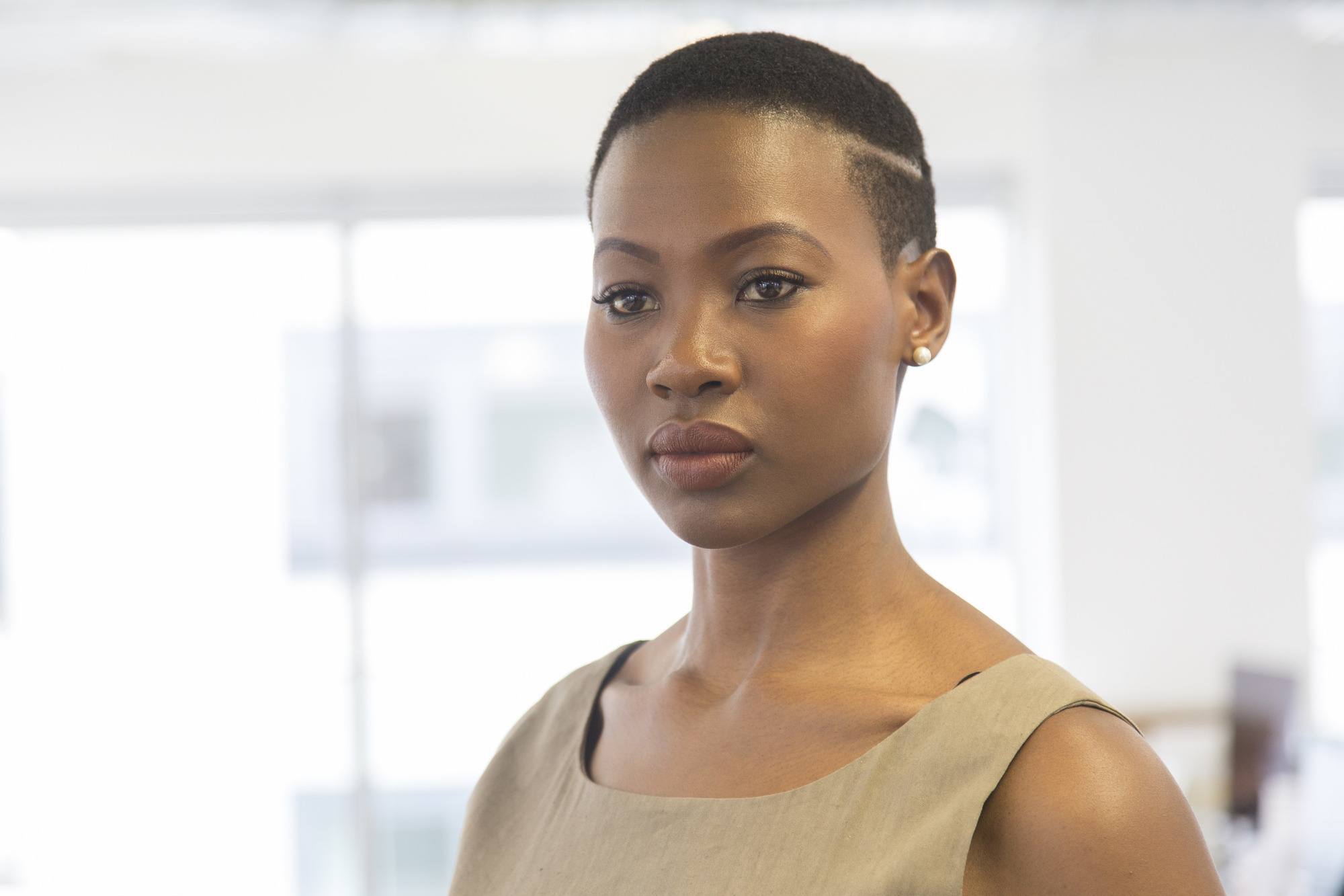 woman with very short natural hair and a deep side part detail
