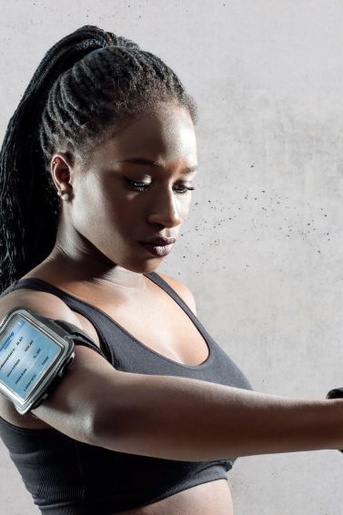 woman with protective hairstyle wearing gym workout clothing