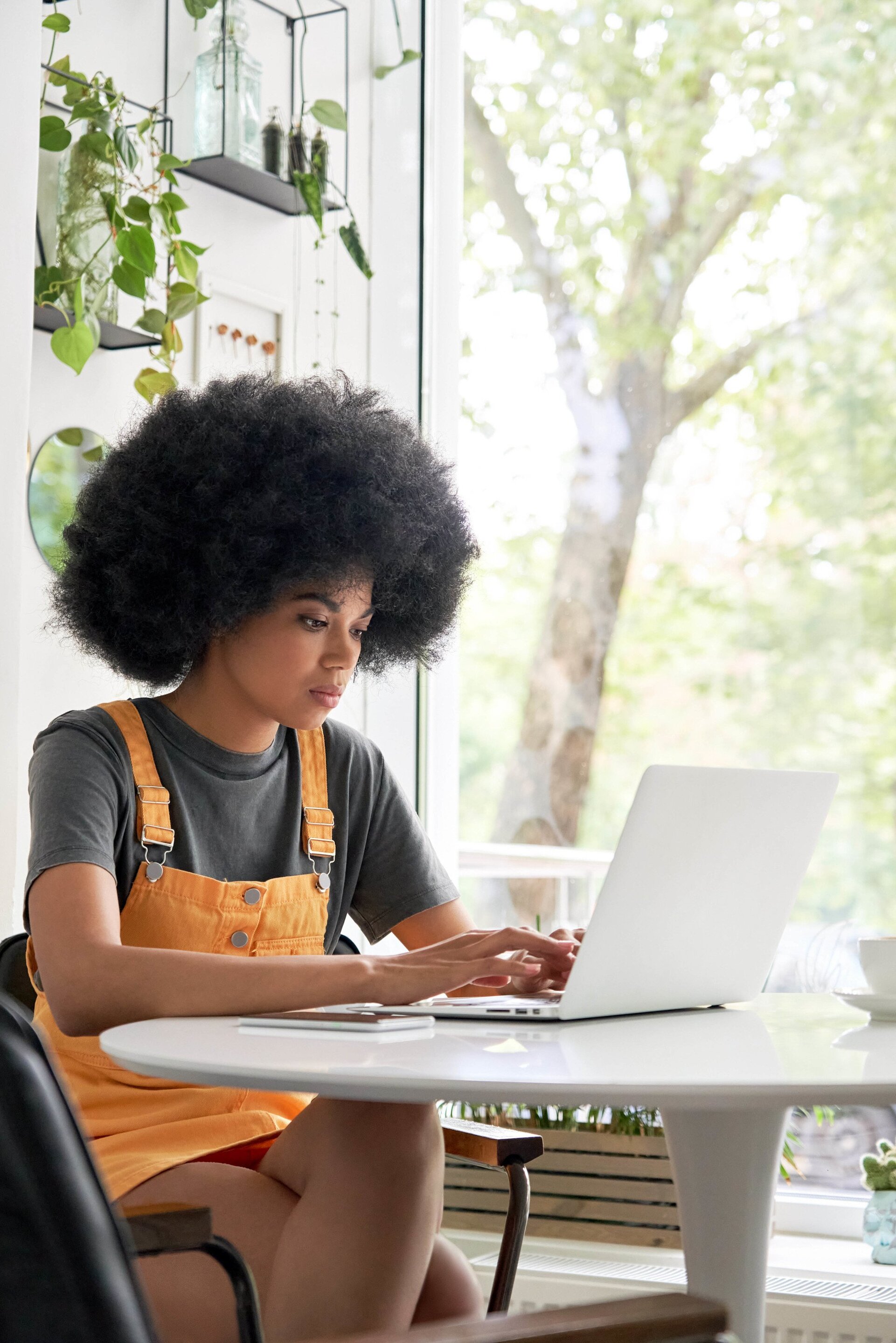 woman in a cafe with a big afro hairstyle