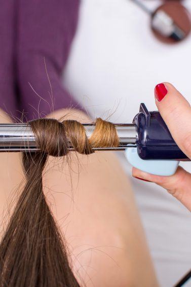 woman using a curling iron