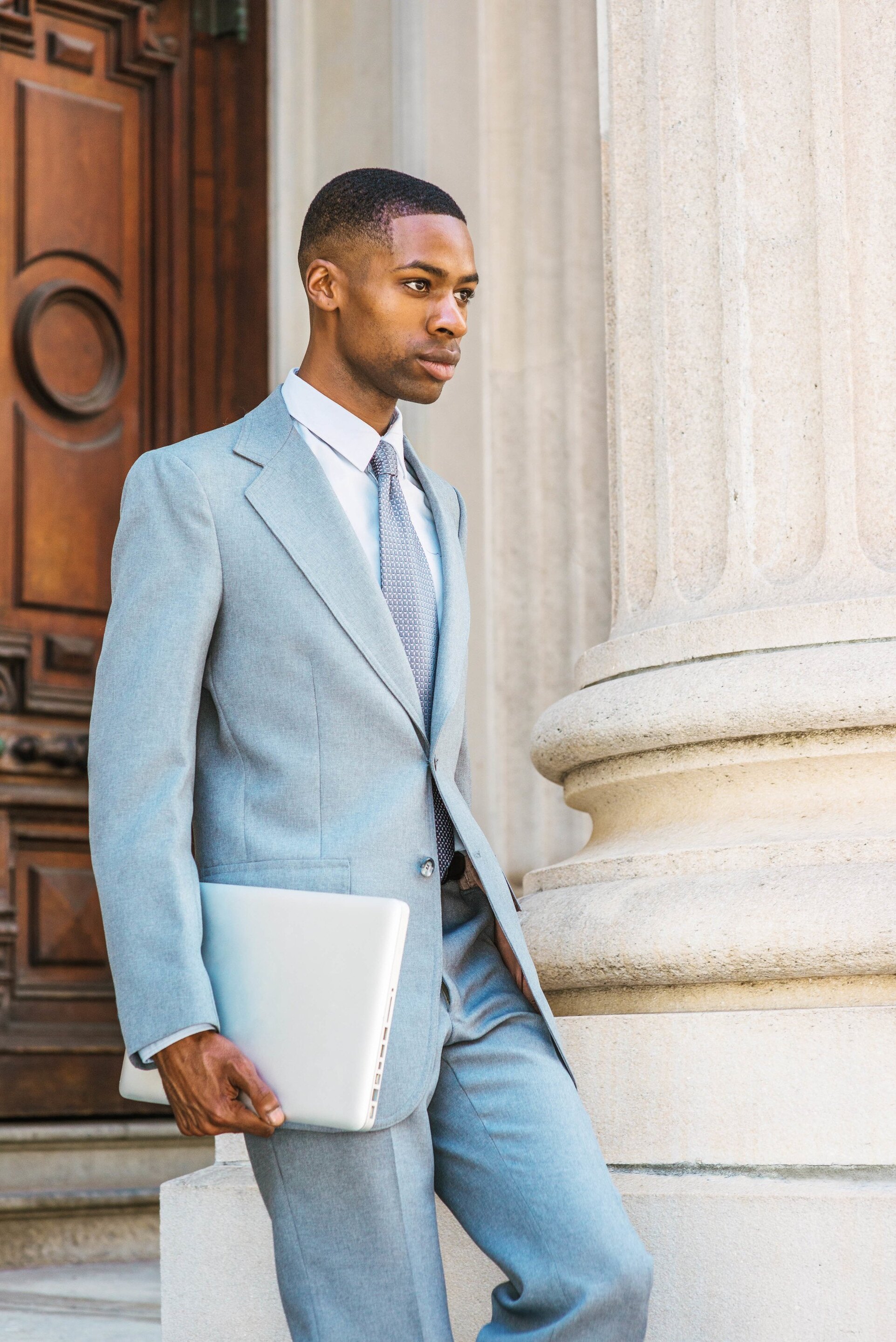 man in a suit with a fade haircut