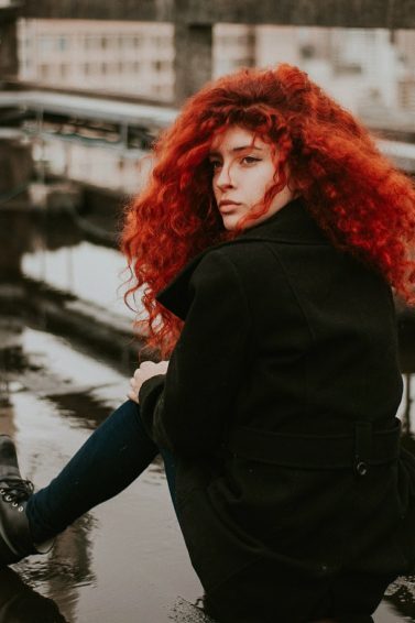 woman with a curly long red hair
