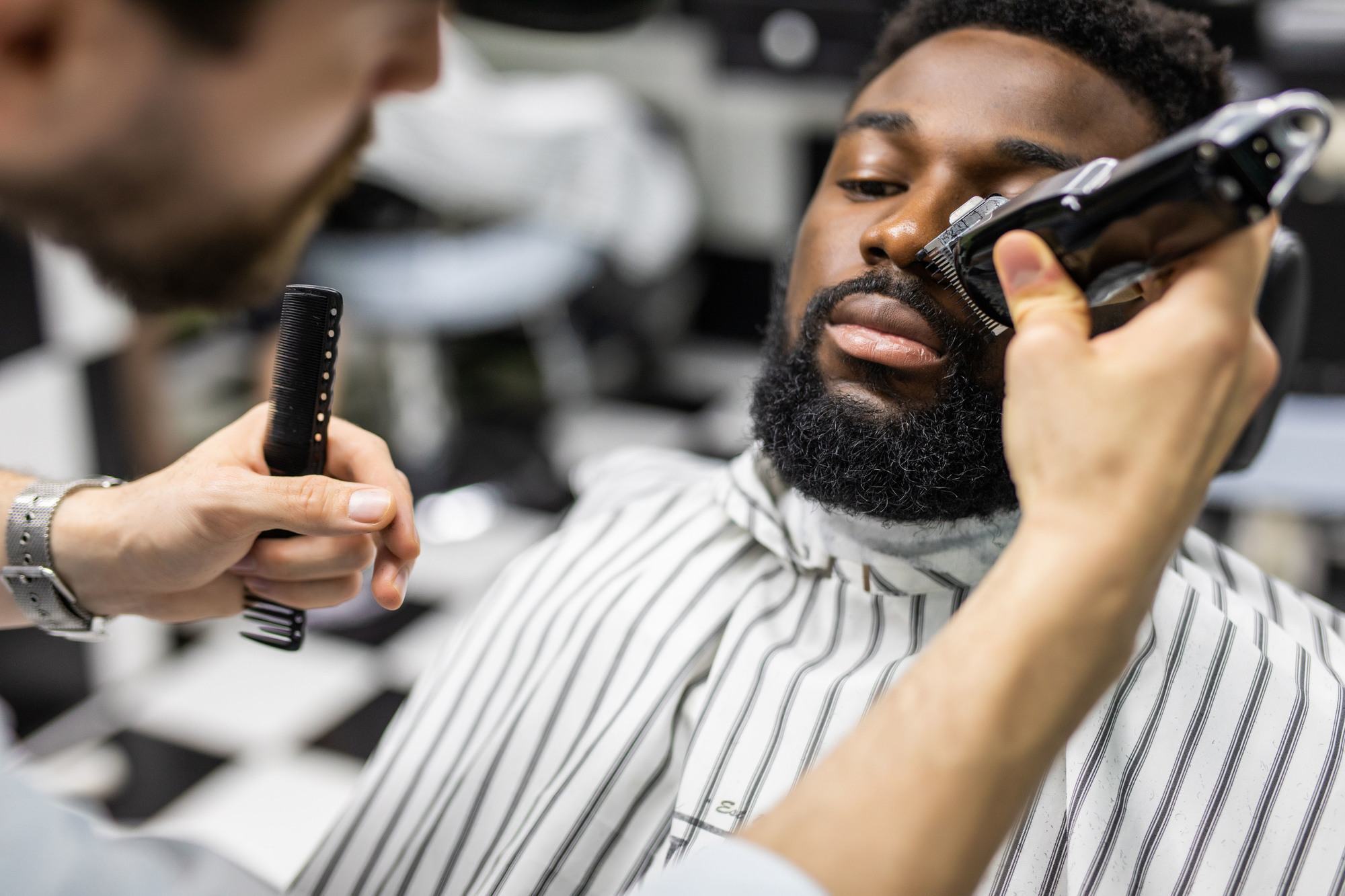 beard care: man getting his beard trimmed professionally