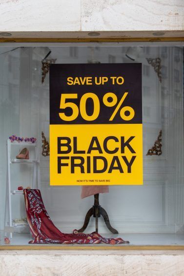image of a shop window with a big black and yellow sign that says